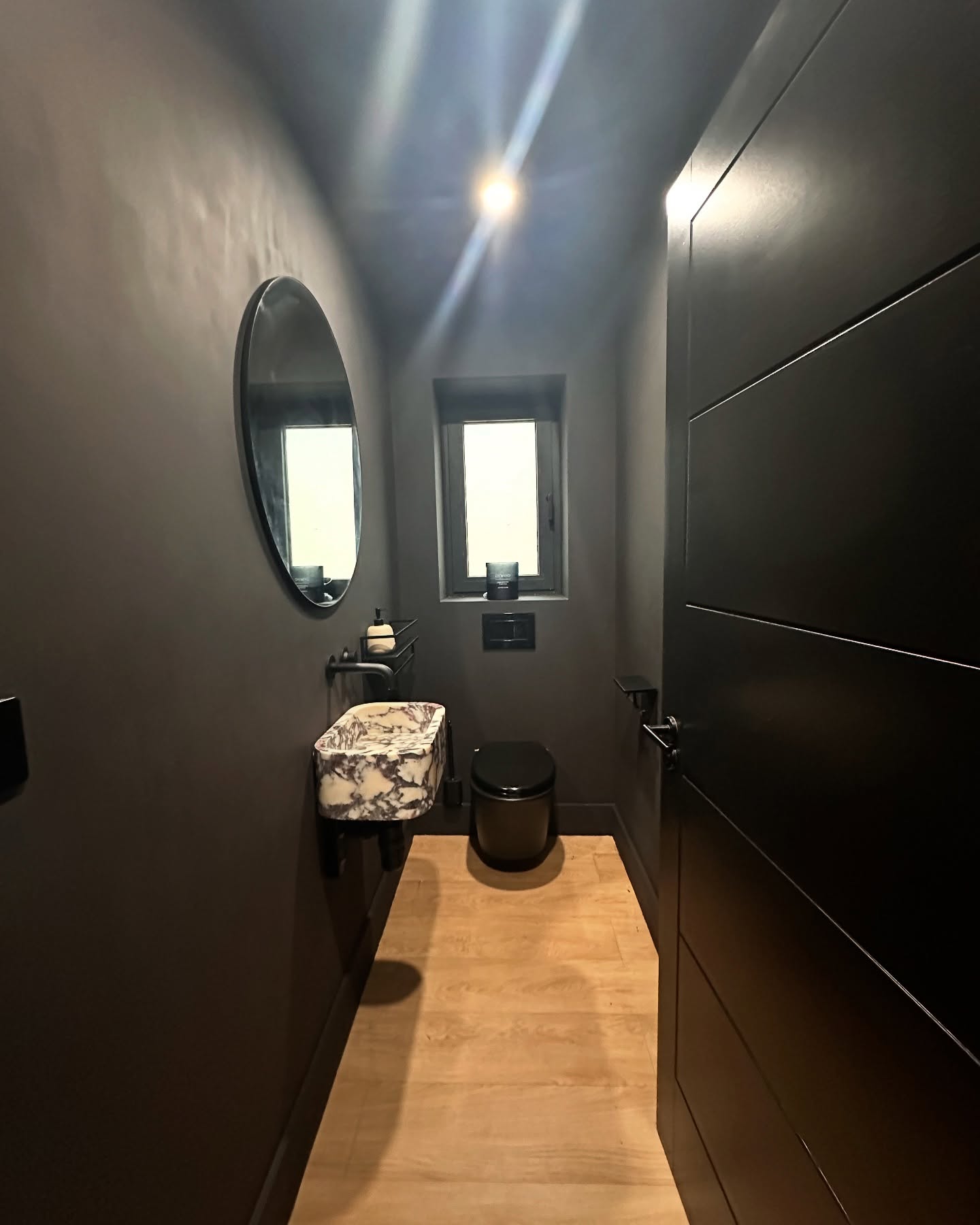 8. Sleek Shadows and Marble Dreams: a Chic Oasis In Compact Spaces