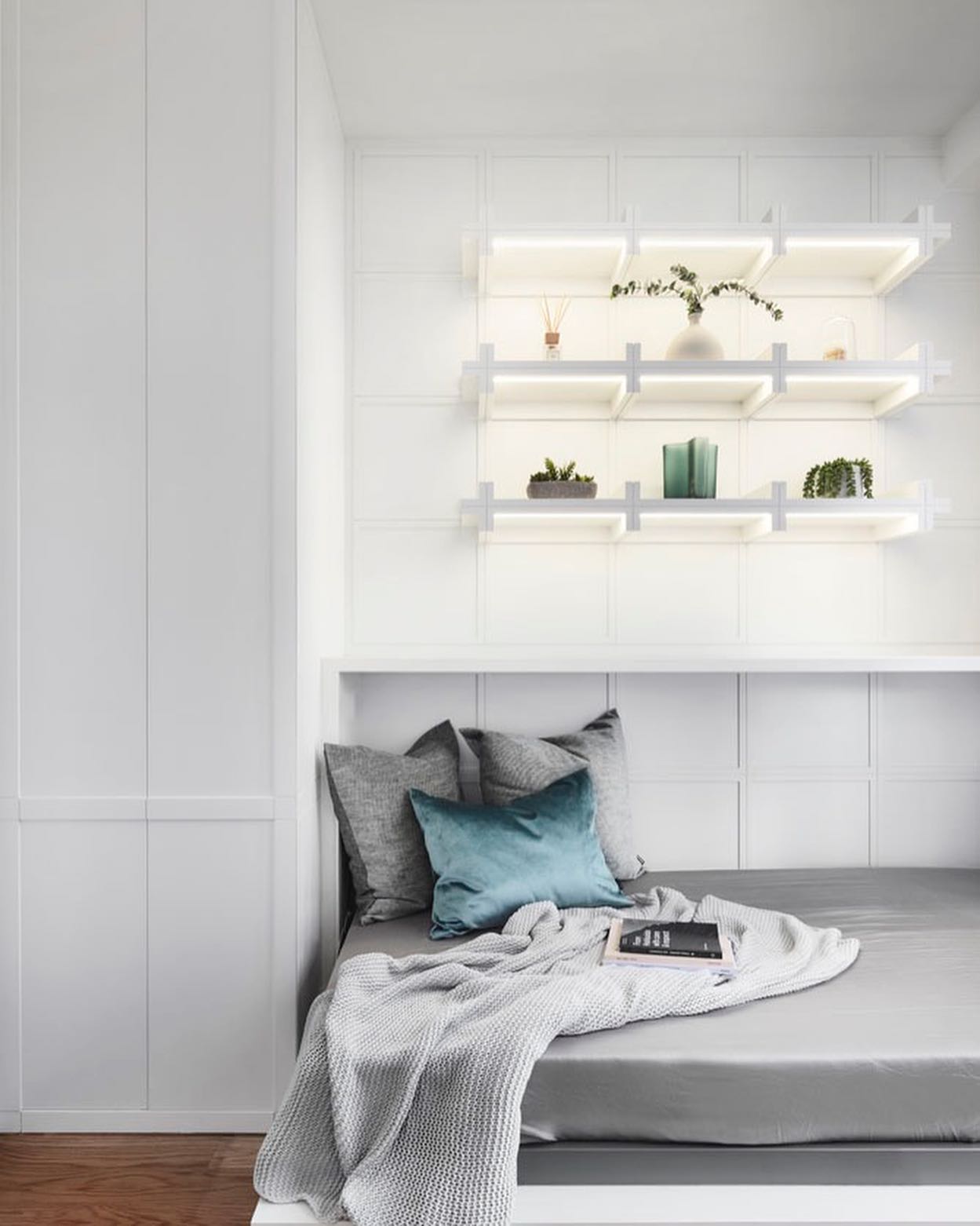 41. Cozy Nook with a Floating Bed and Geometric Wall Art