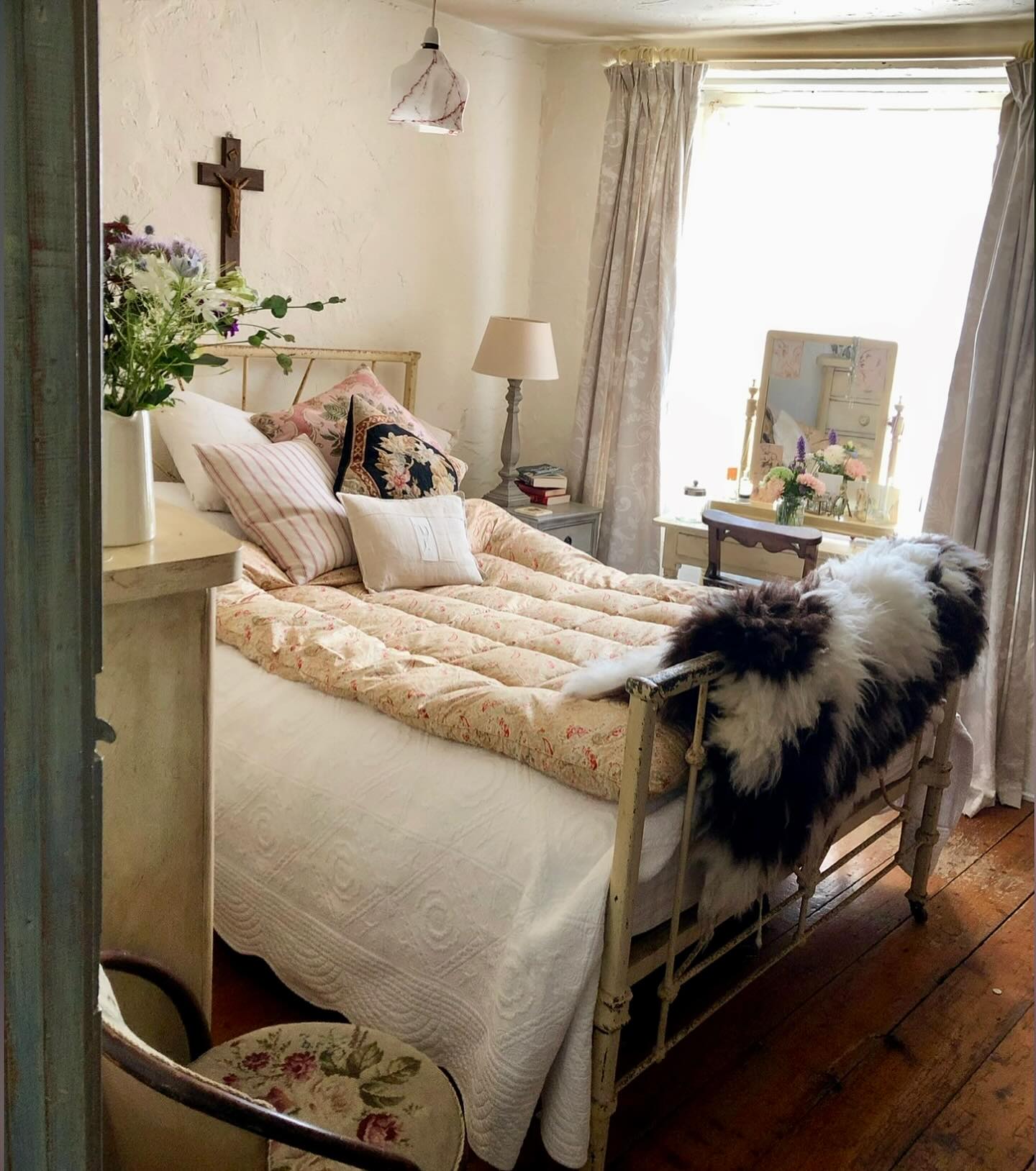 41. Vintage Brass Bed with Blue Velvet Cushions and a Retro Alarm Clock
