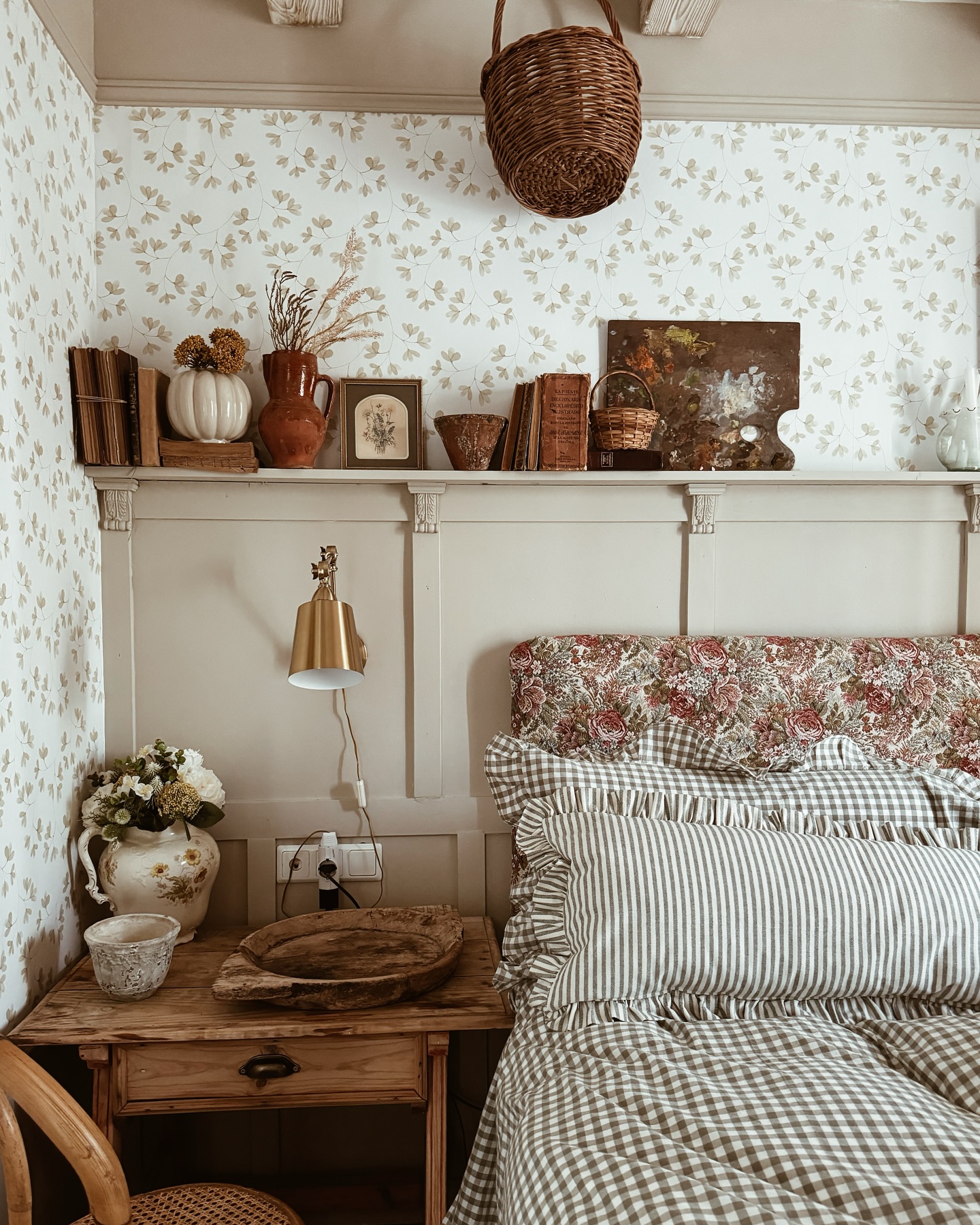 34. Velvet Canopy Bed with Brass Accents and Floral Wallpaper Accent Wall