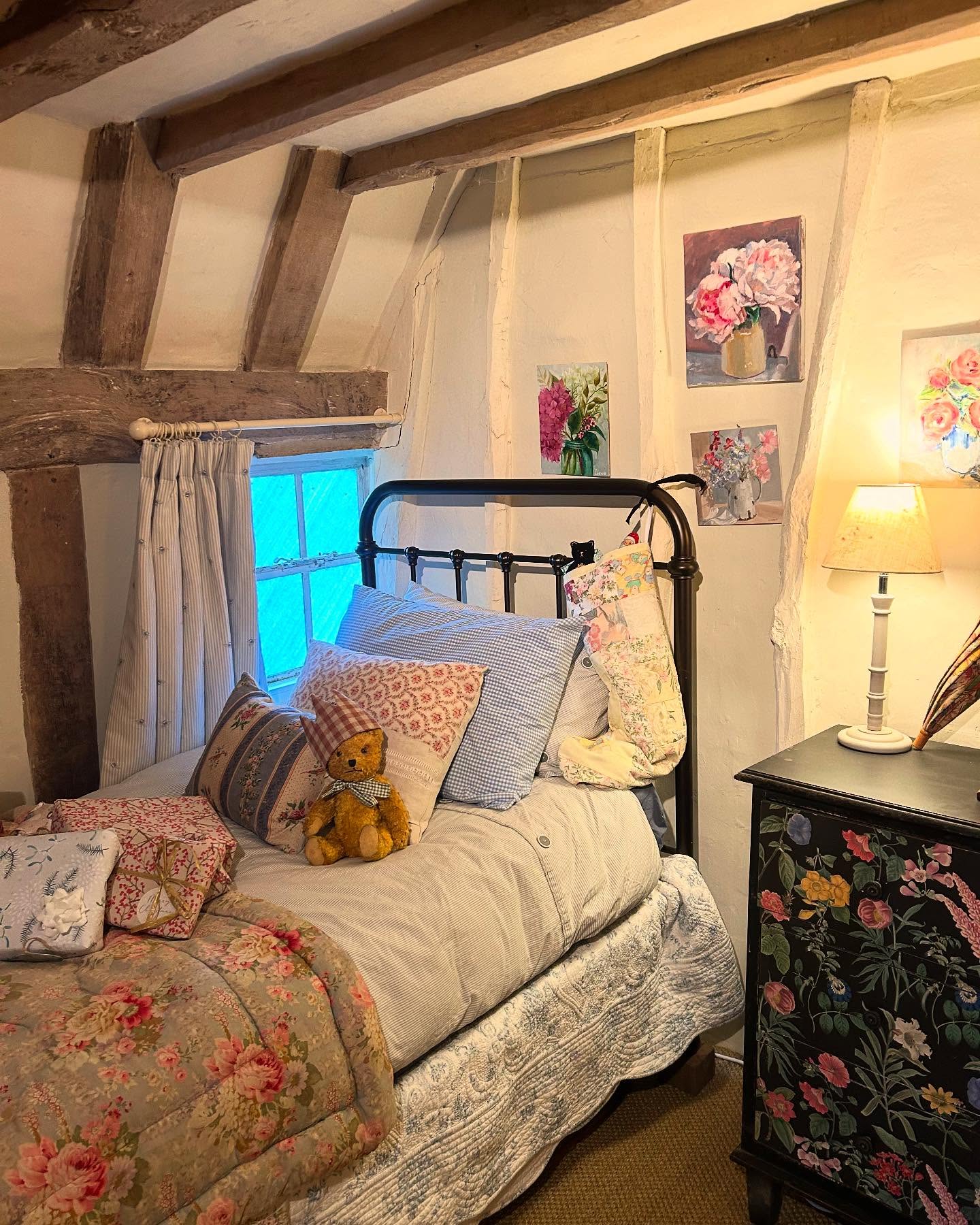 35. Vintage Bedroom with a Canopy Bed and Floral Wallpaper Waltz