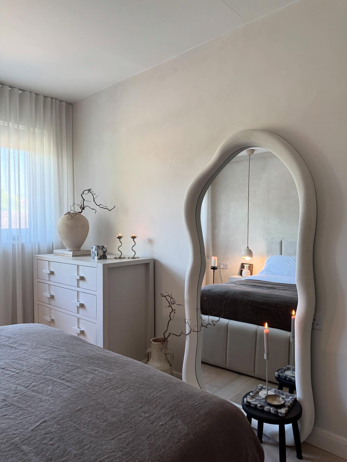 18. the Geometric Reflection Of a Sleek Black Frame Against a Soft Taupe Wall