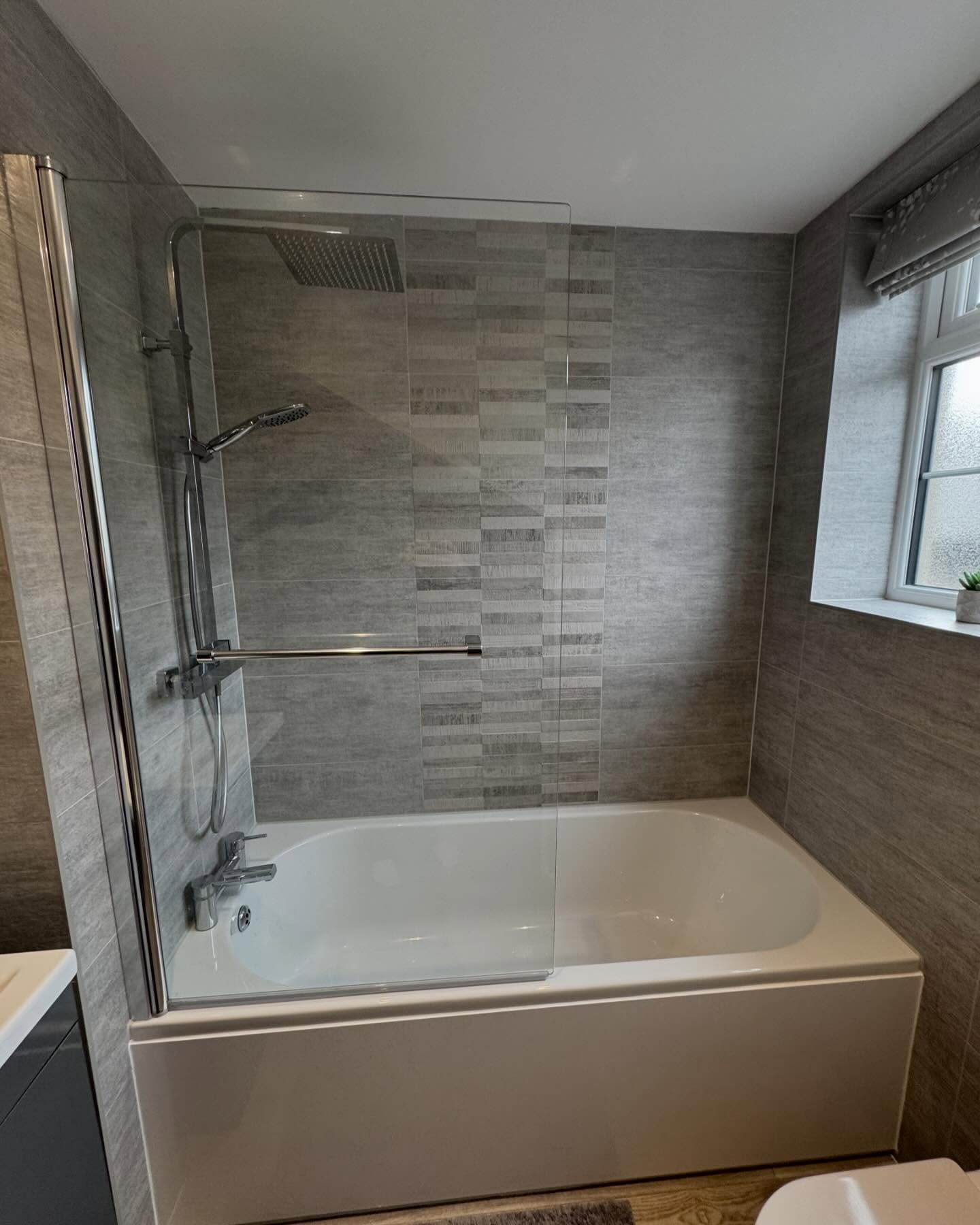 3. Sleek Serenity: Harmonizing Textured Tiles and Soft Curves In Modern Bath Spaces