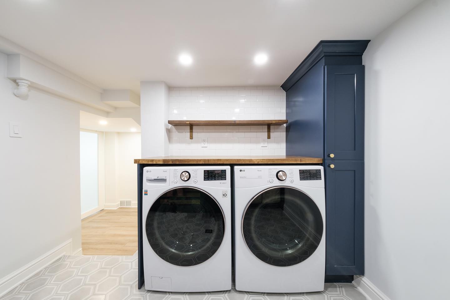 22. Sleek Serenity: a Modern Laundry Escape with Coastal Charm