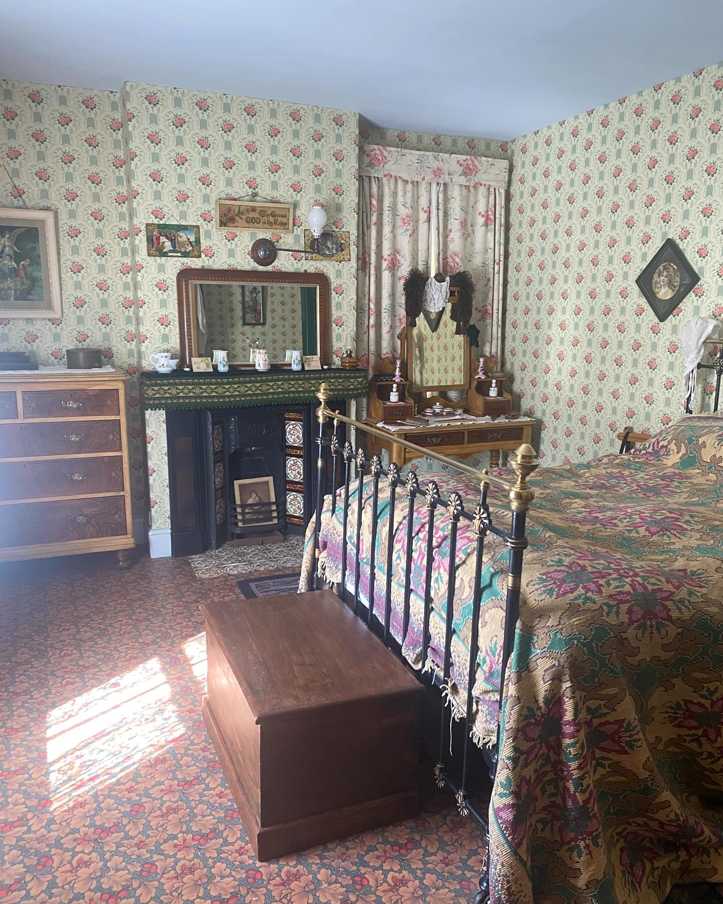 31. Antique Brass Bed with Draped Canopy and Persian Rug Accent