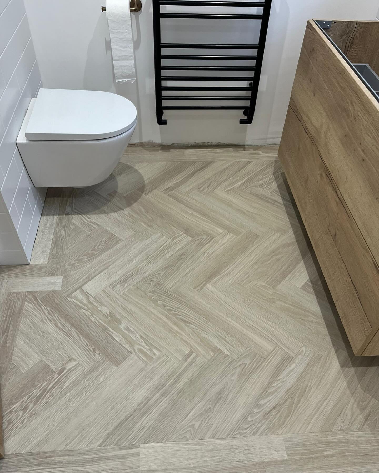 42. Herringbone Harmony: Embracing Minimalist Elegance In Your Bathroom