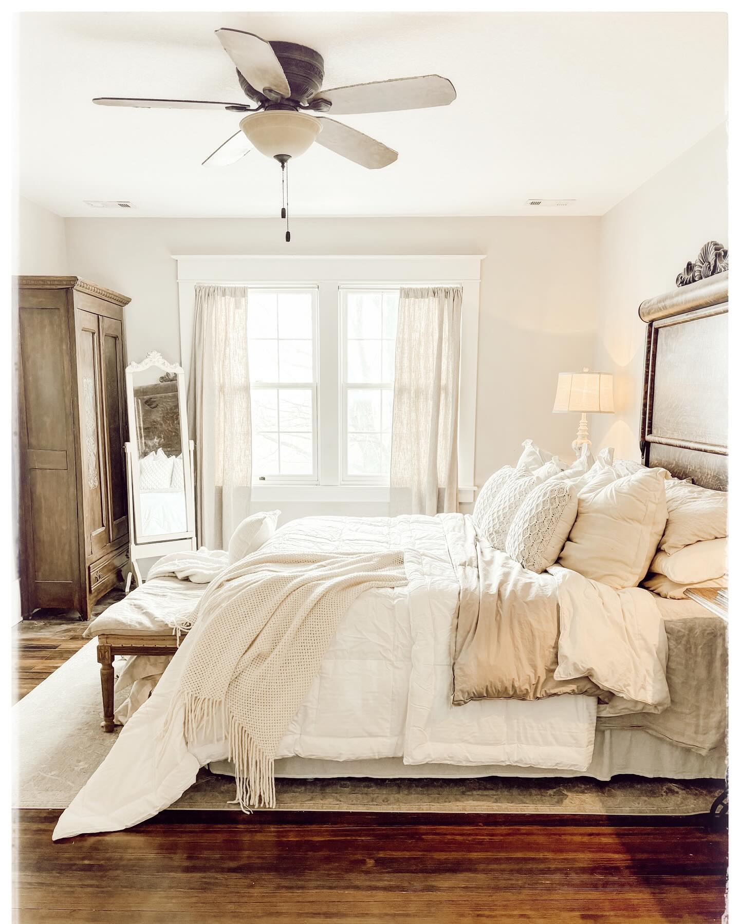 10. Antique Brass Bed Frame with Floral Bedding and Faded Rose Wallpaper