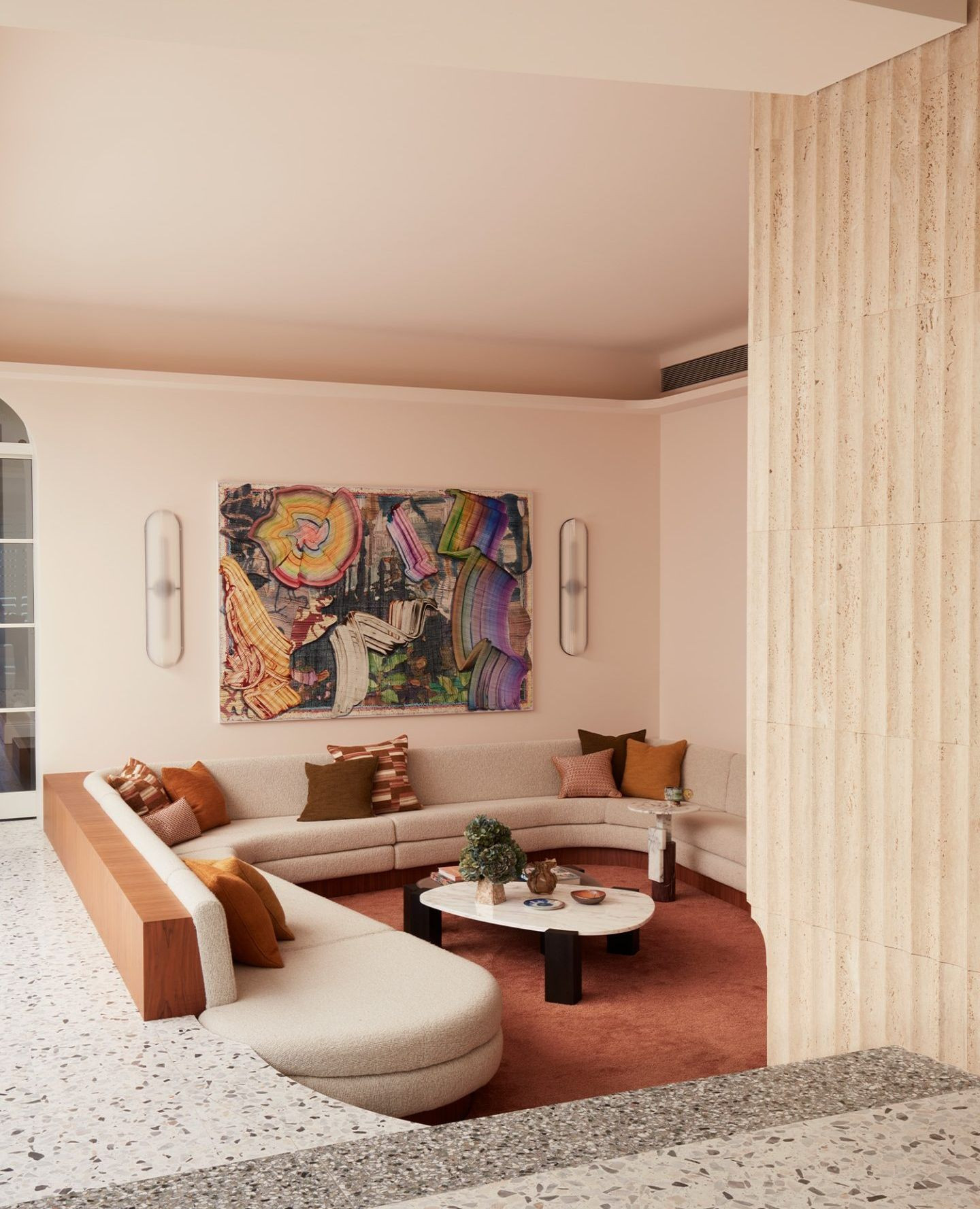 17. Curved Comfort Meets Artistic Flair In a Cozy Corner