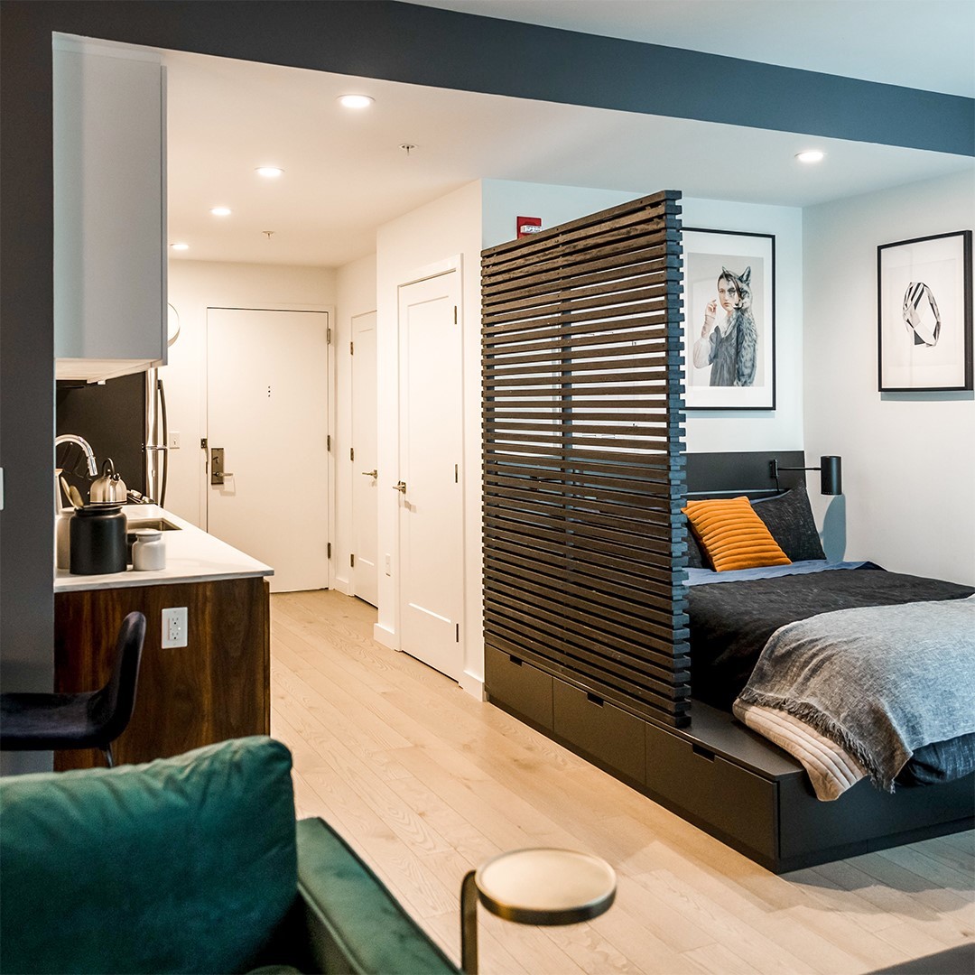 12. Compact Urban Oasis with Geometric Wall Art and Suspended Bed