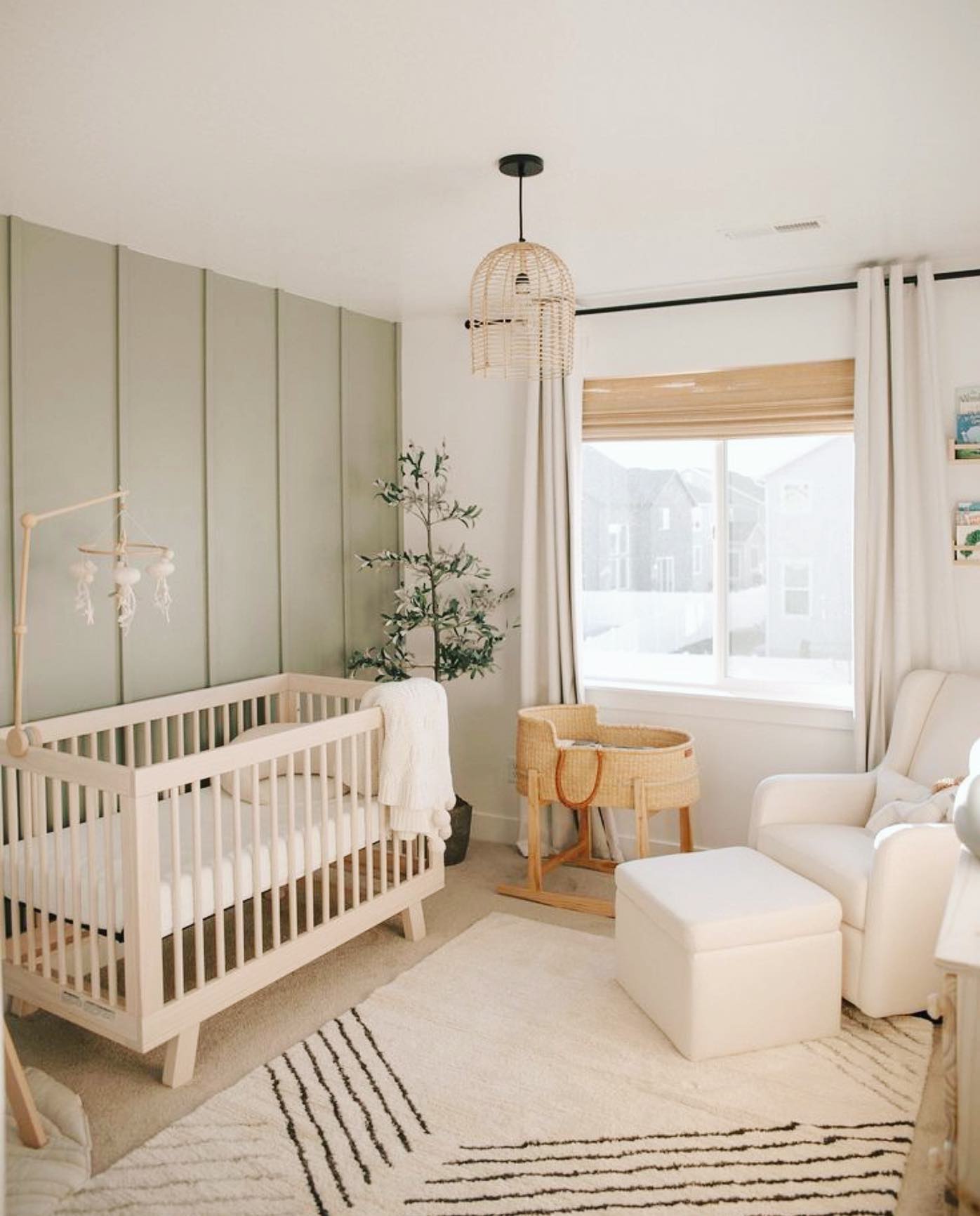 16. Sage Green Cradle with Whimsical Mushroom Mobile In a Sunlit Corner