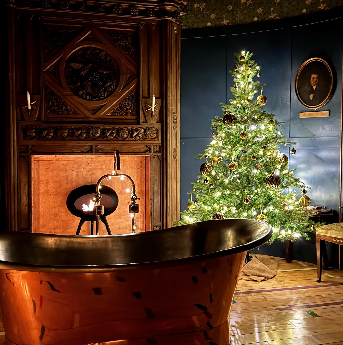 22. Festive Pinecones and Crimson Ribbons Adorning a White Porcelain Sink