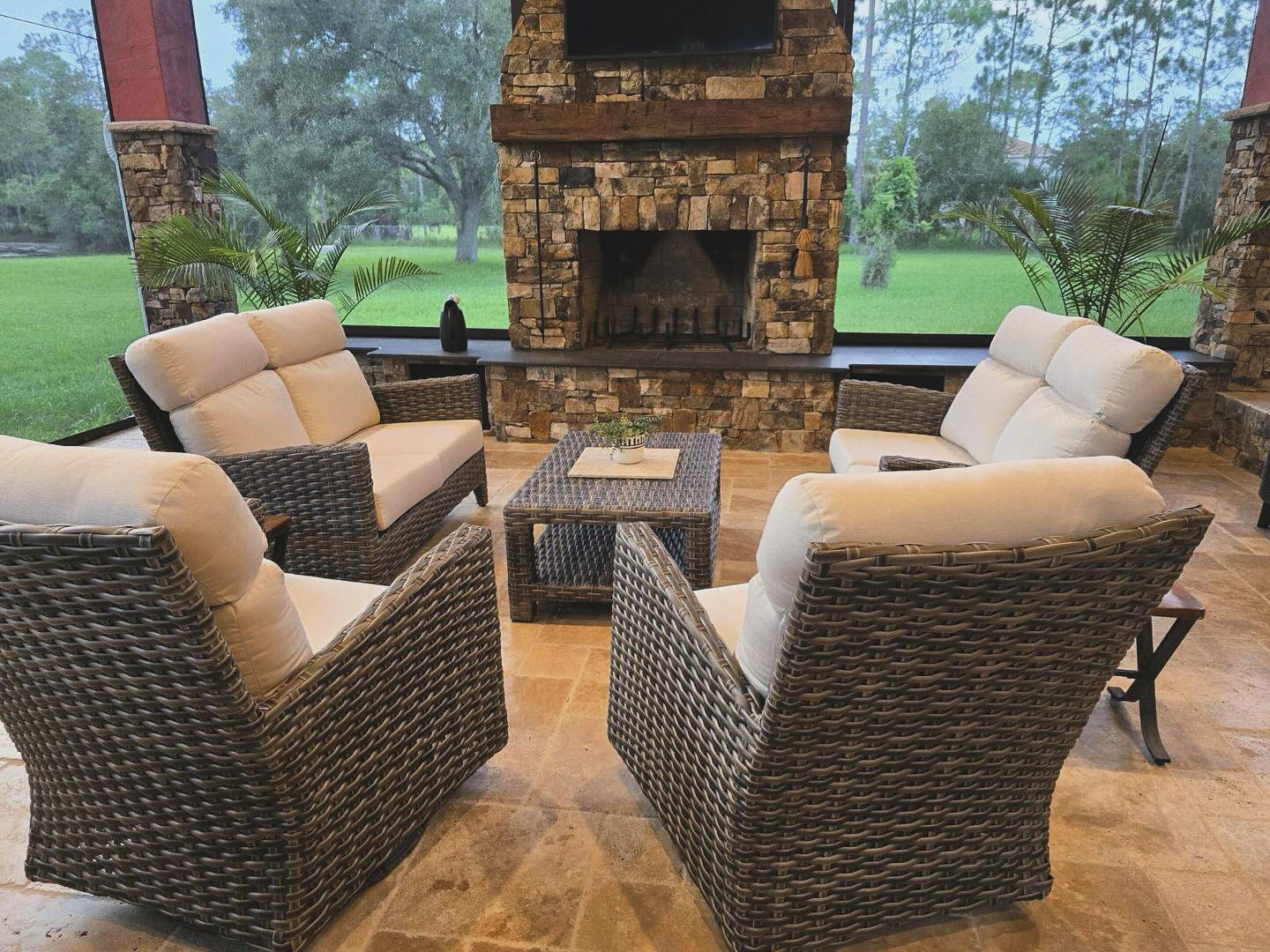 12. a Sunlit Wicker Ensemble with Geometric Blue Cushions and a Mosaic Side Table