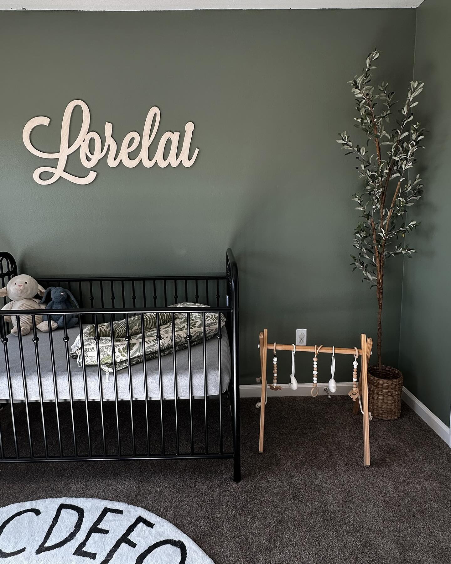 43. Soft Mossy Greens and Delicate Dandelion Wall Art In a Cozy Nursery Nook