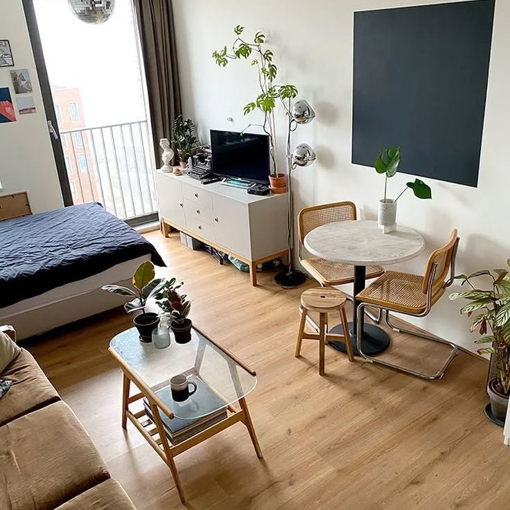 21. the Crimson Sofa and Geometric Rug In a Sunlit Studio Haven