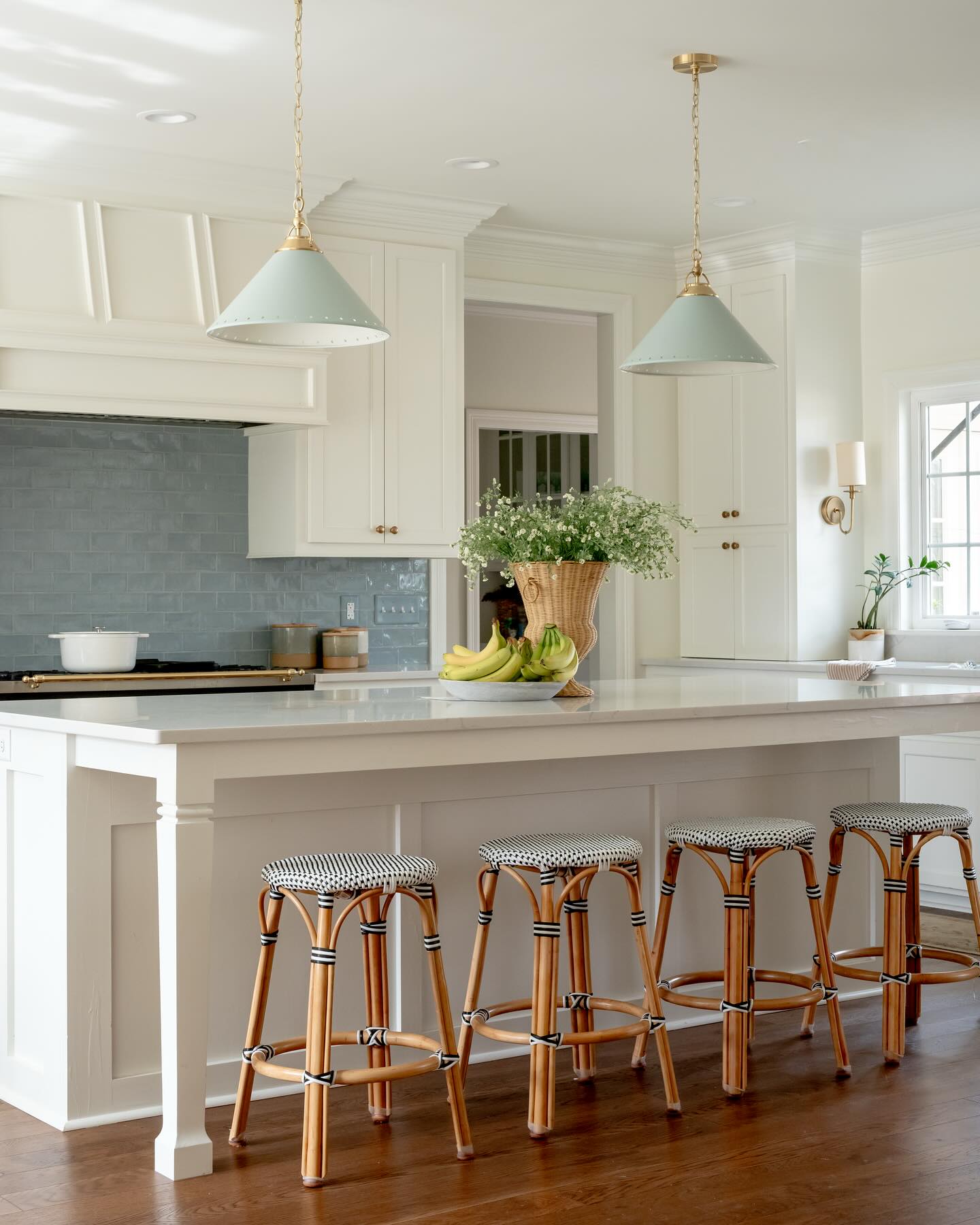 10. White Cabinets with Butcher Block Countertops and Geometric Backsplash Mosaic