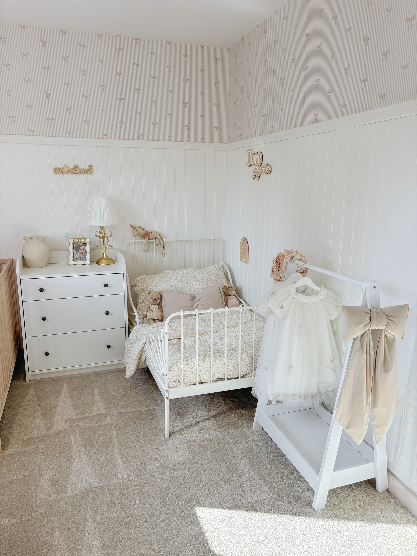 24. Soft Whisper Of Birch In Monochrome: a Single Wooden Crib Against Crisp White Walls