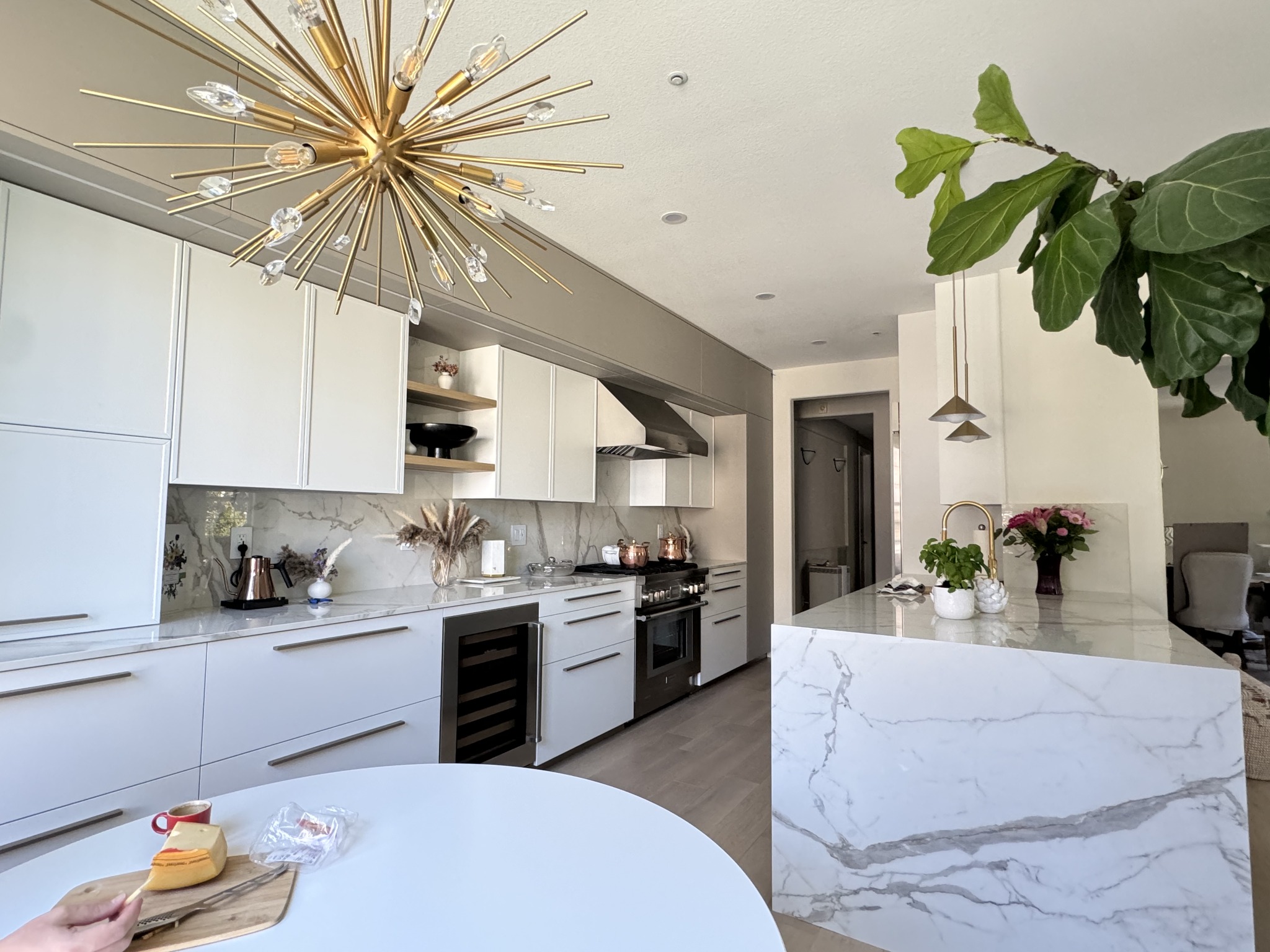 23. Sunlit Sage Serenity: a Kitchen with Botanical Glass Panels and Brass Accents
