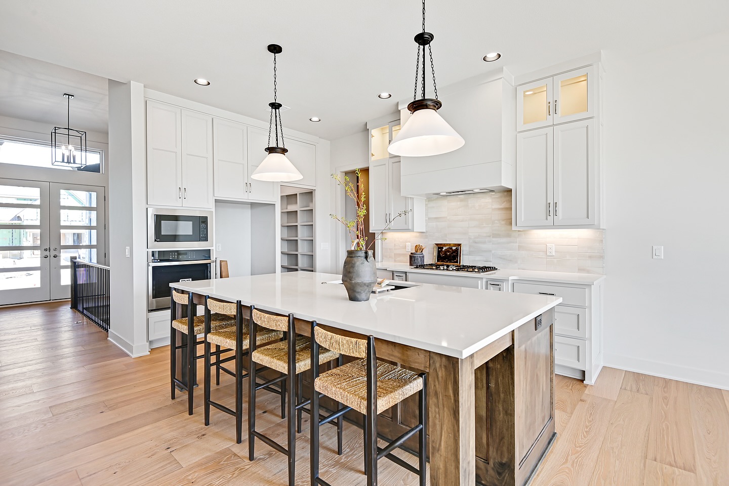 4. Glossy Midnight Blue Cabinets with Brass Accents and Geometric Tile Backsplash