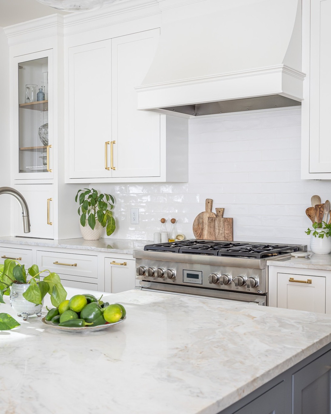 32. Glossy White Cabinets with Vintage Brass Accents and Industrial Lighting
