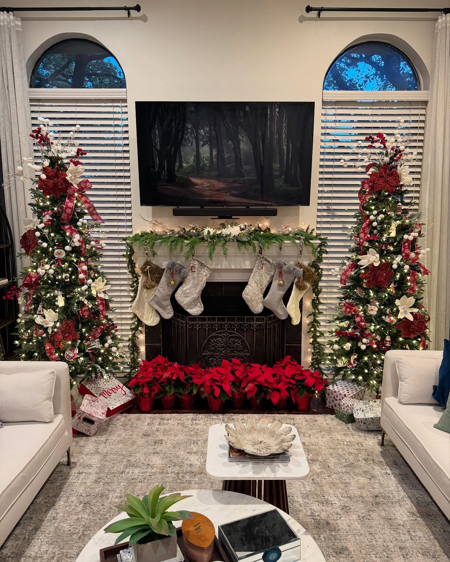 10. Crimson Ribboned Candles and Snowy Pine Cones Christmas Centerpiece