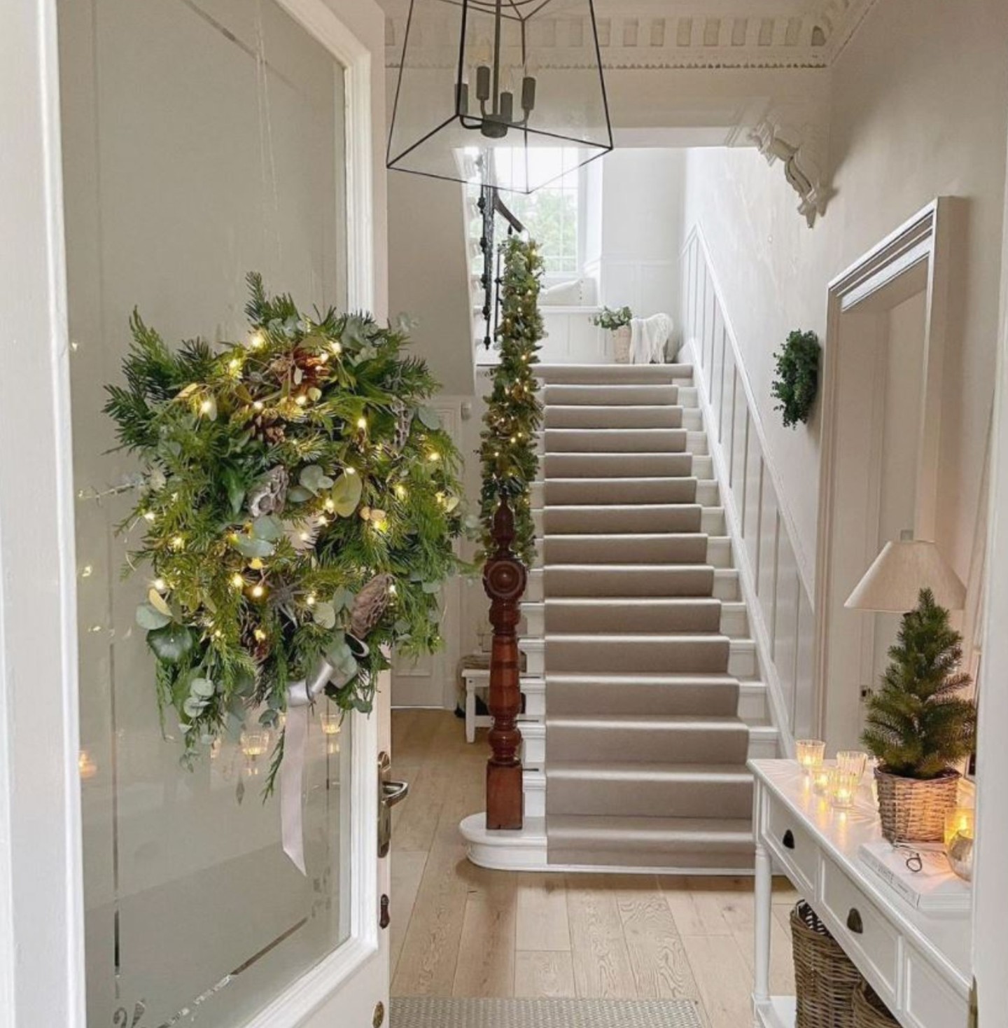 17. Glittering Pinecones and Ribboned Ornaments Draped Over a Rustic Wooden Ladder