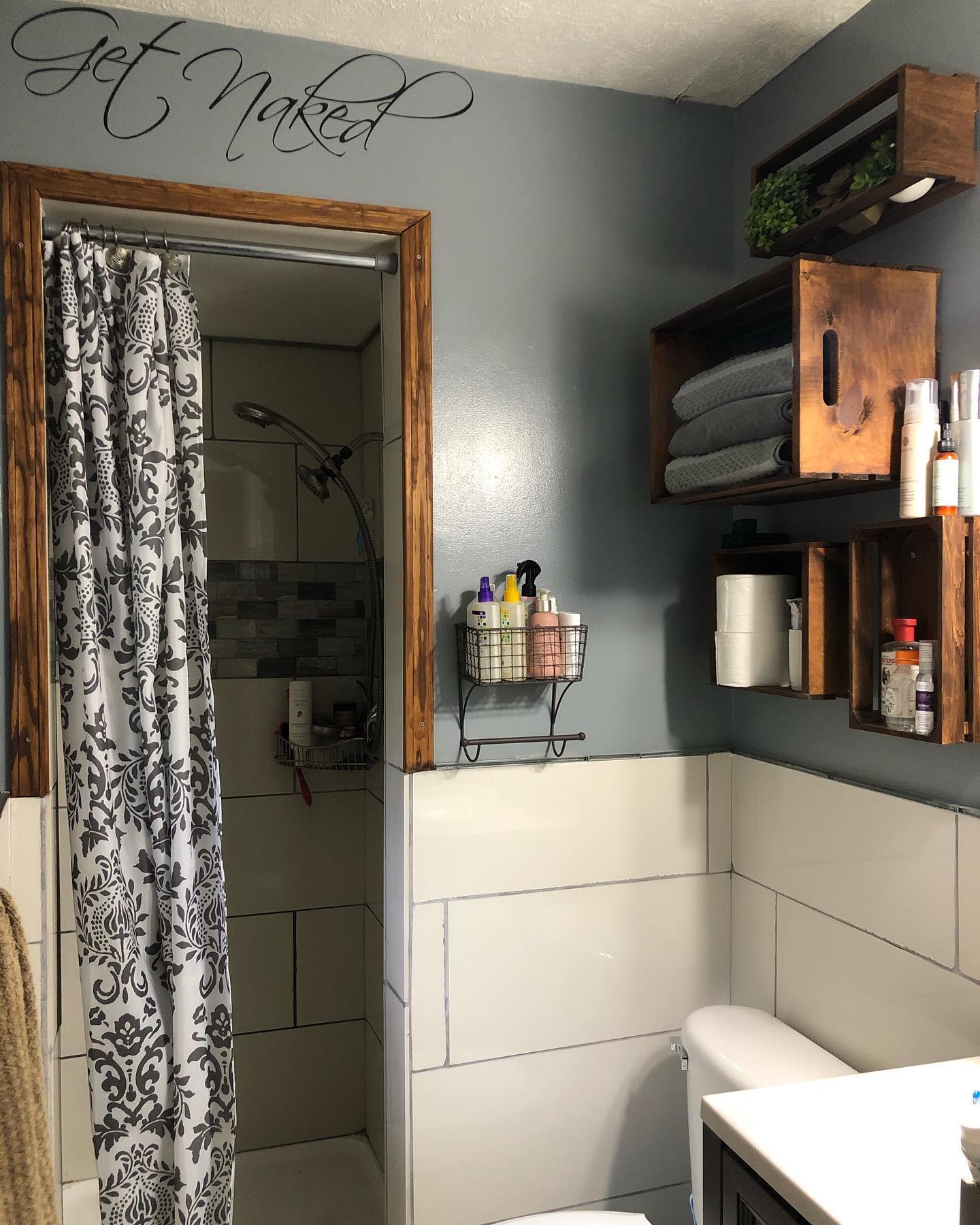 9. Under-the-sink Sliding Shelves with Polka-dot Curtain Concealment