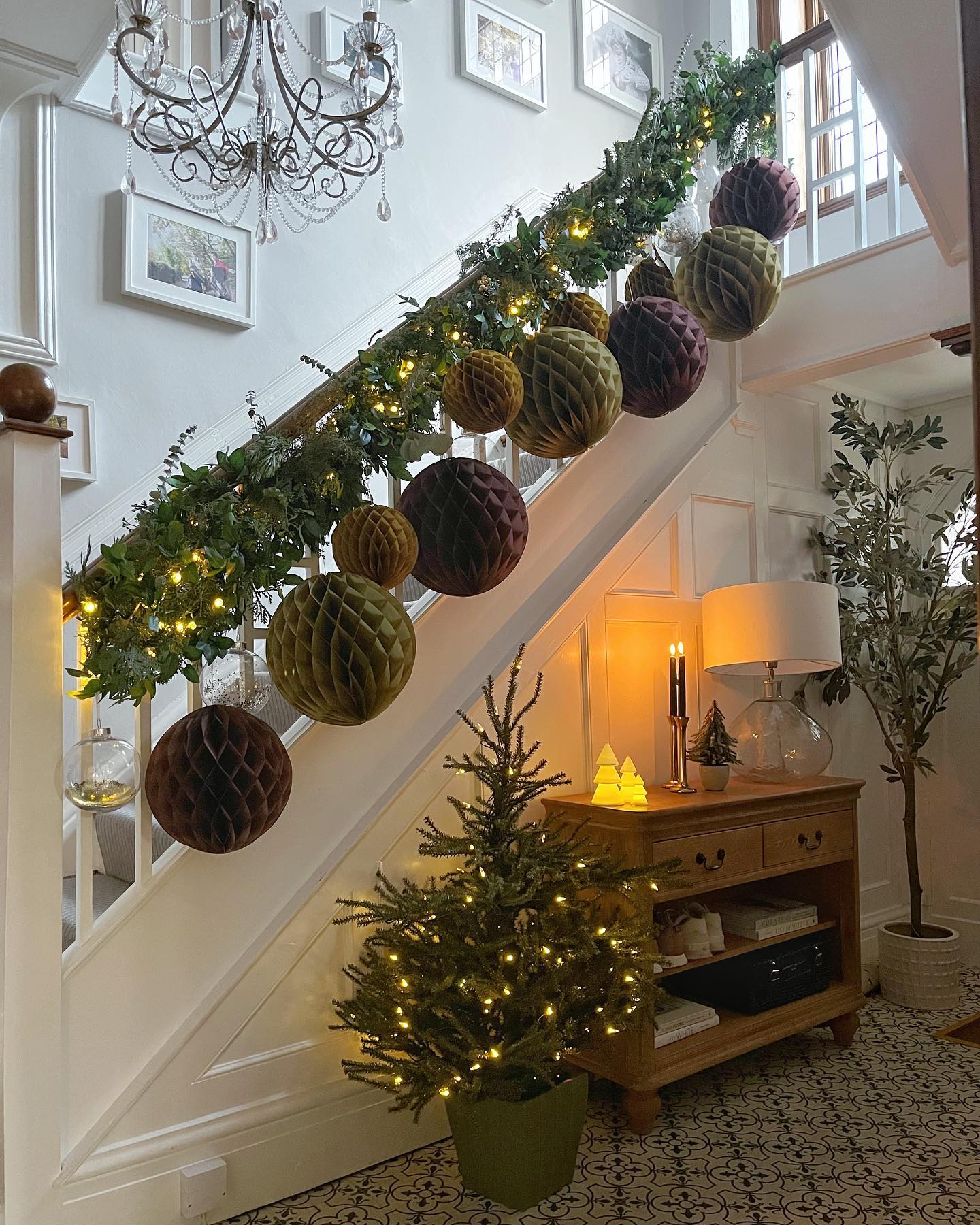 25. Crimson Ribbons and Golden Baubles Cascade Down a Spiral Staircase