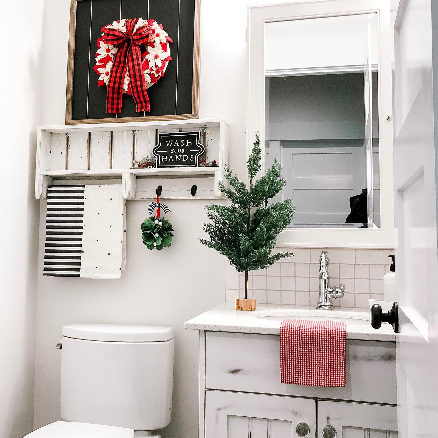 6. Festive Reindeer Towel Art and Pine Cone Garland on a White Sink