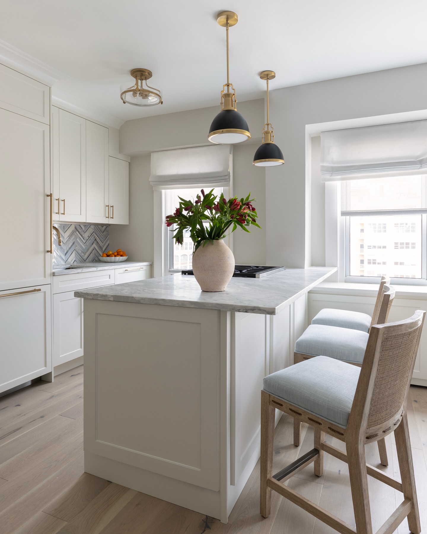 11. Glossy White Cabinets with Subtle Beaded Insets and Brass Hardware Accents