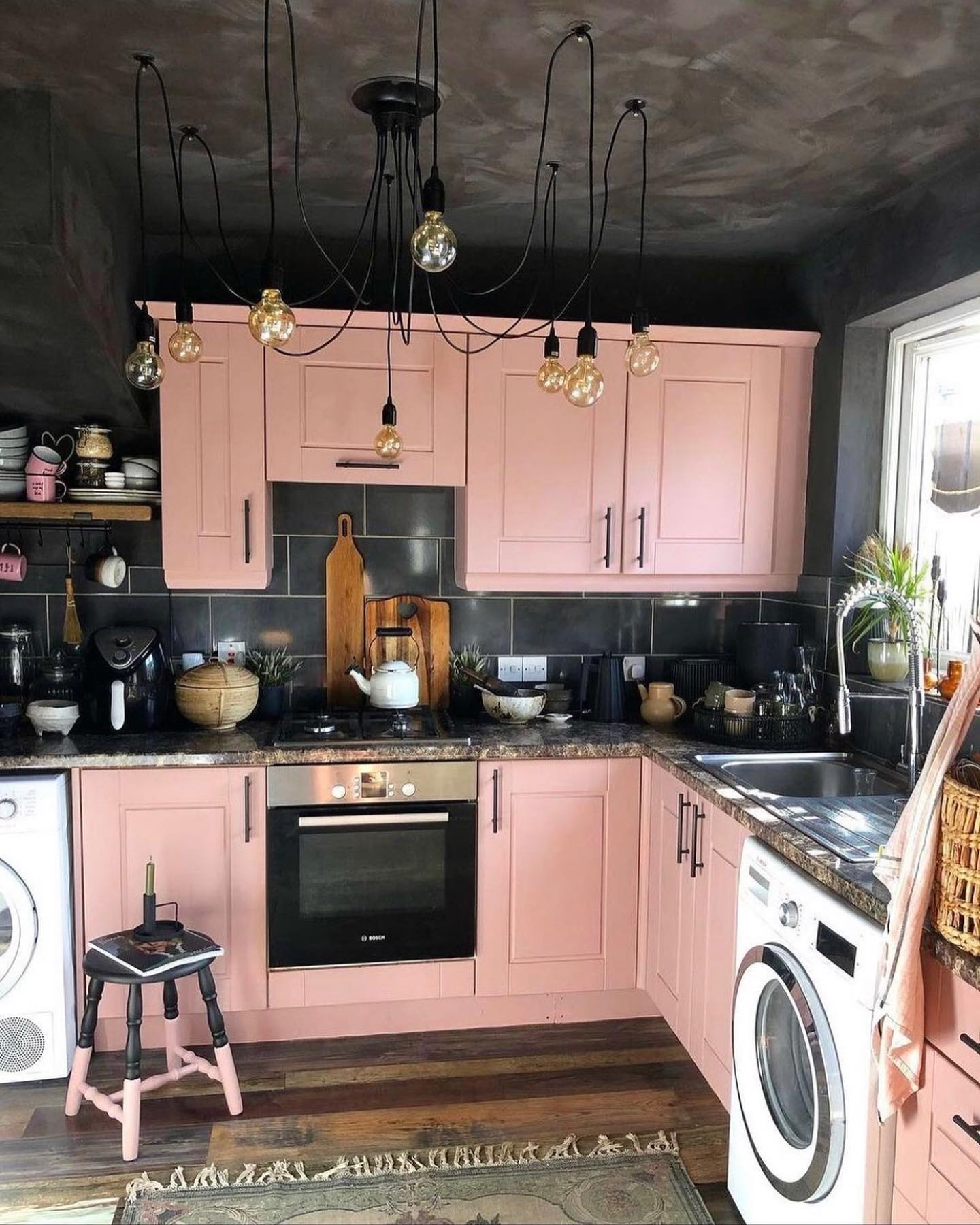 2. Cotton Candy Clouds Meet Retro Charm: a Kitchen with Bubblegum Pink Cabinets and Vintage White Appliances