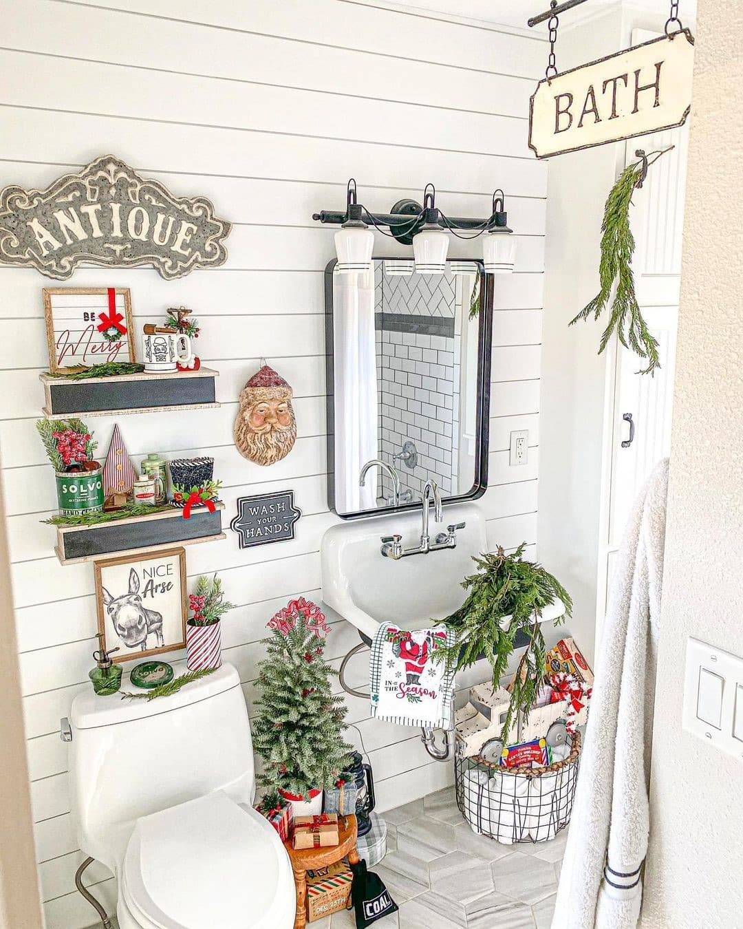 23. Festive Frosty Pinecones and Crimson Ribbons on a White Ceramic Sink
