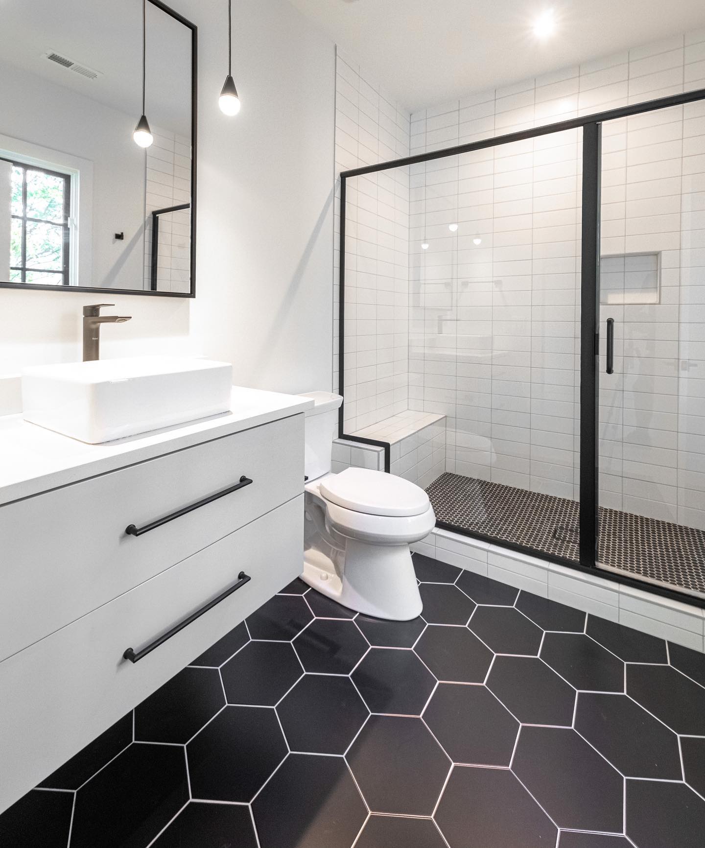 6. Monochrome Mosaic Marvel with Circular Accents and Minimalist Fixtures