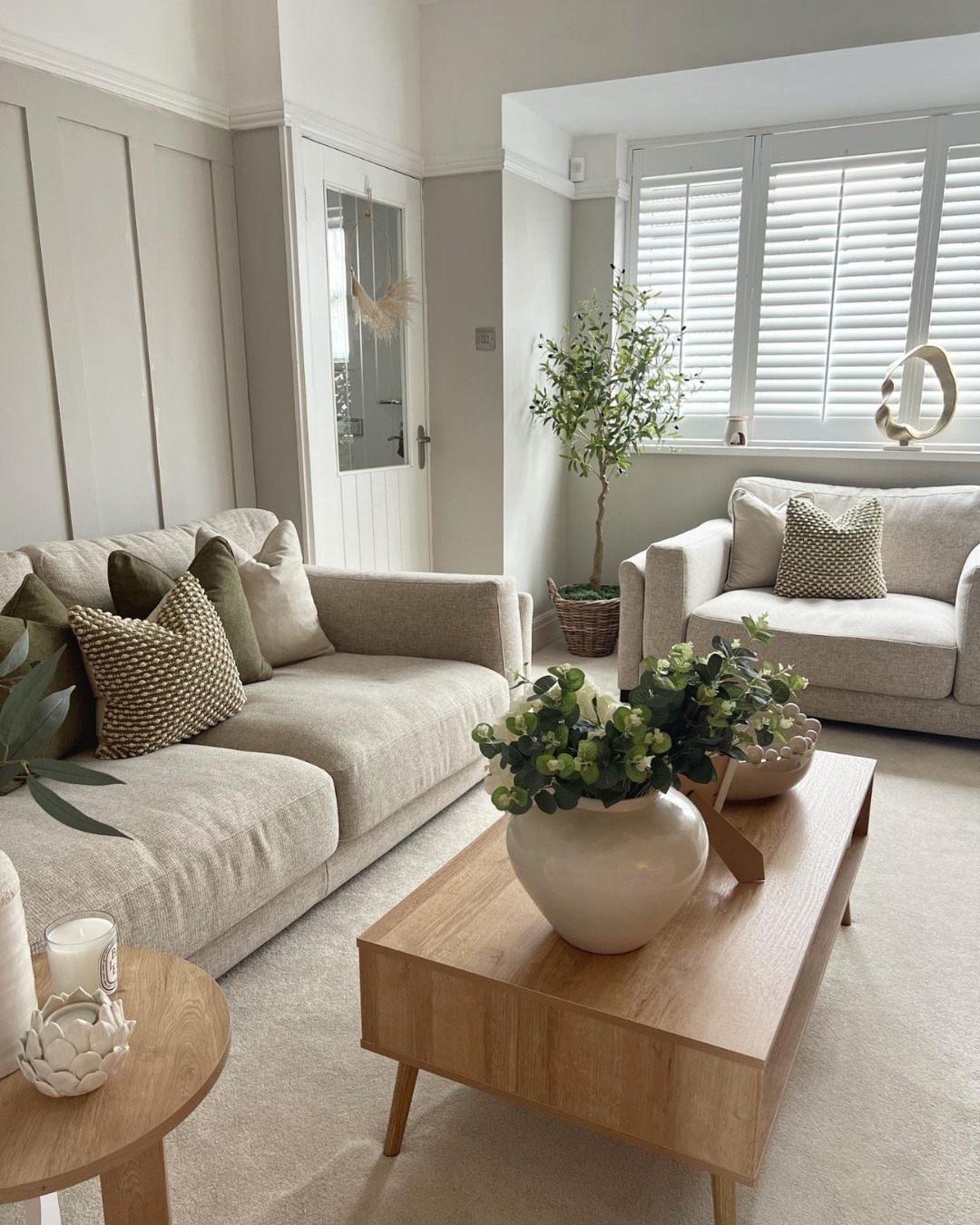 42. the Soft Taupe Sofa with Geometric Scatter Cushions Against a Monochrome Wall