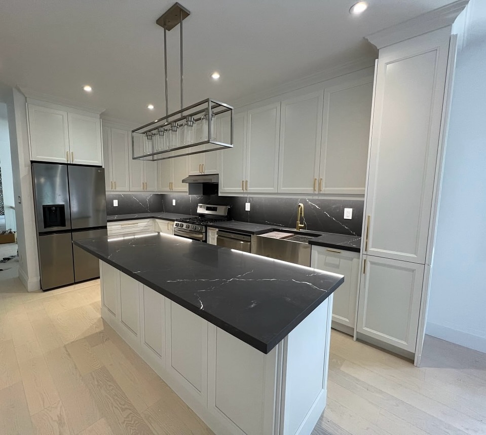 25. Frosted Glass Panels and Geometric Hardware on Shaker Cabinets