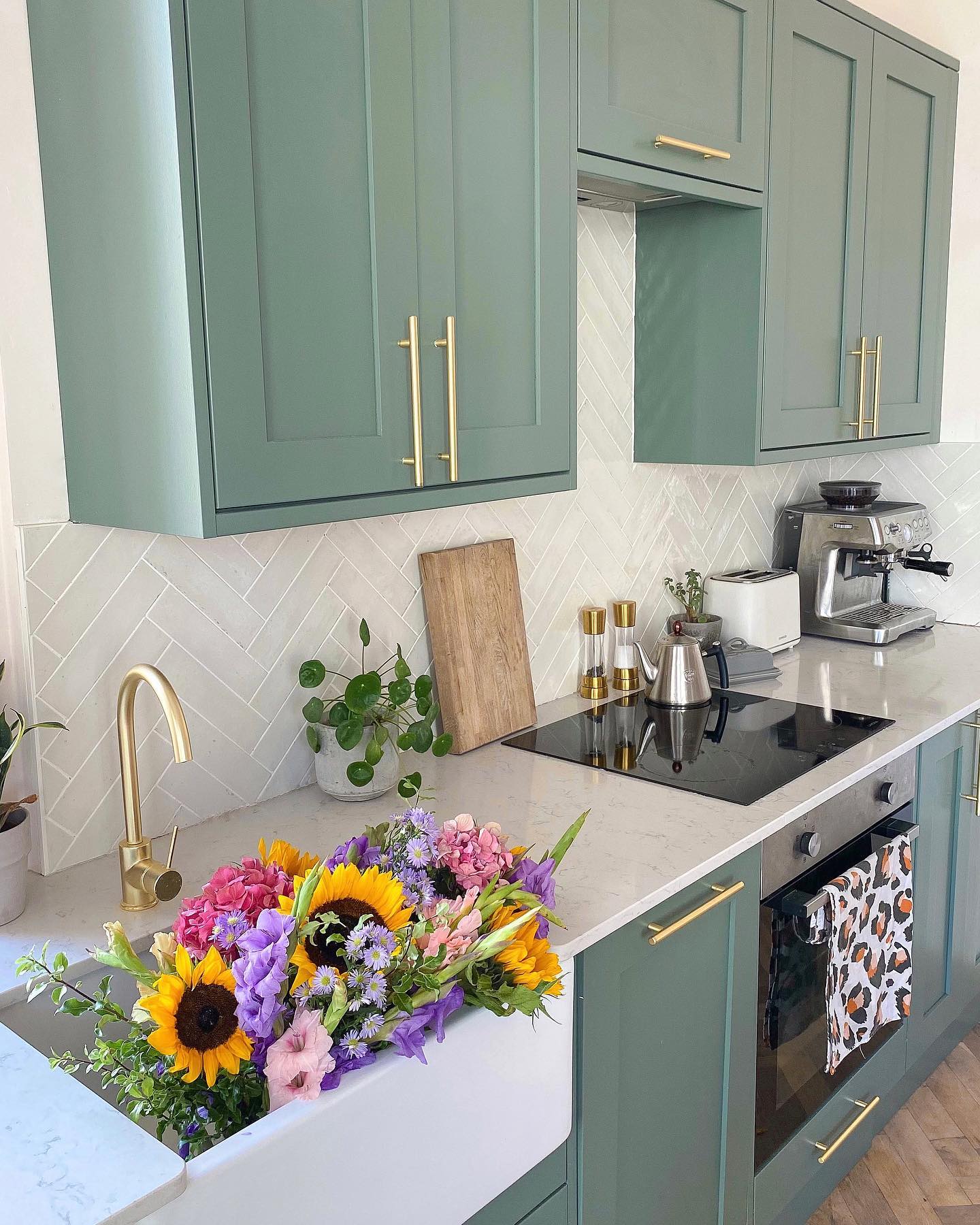 26. Verdant Vine Veneer with Brass Accents Kitchen Design