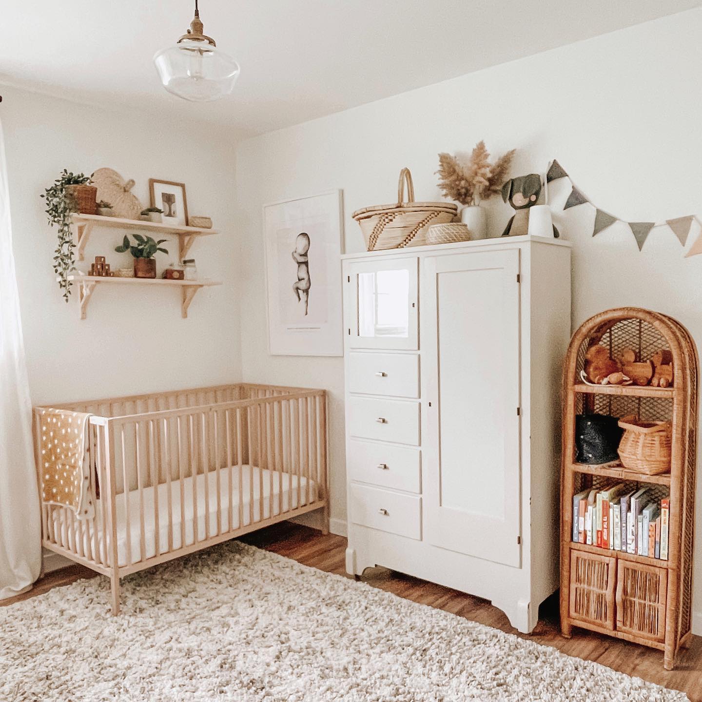 11. a Single White Crib Against a Bare Wall with a Minimalist Mobile