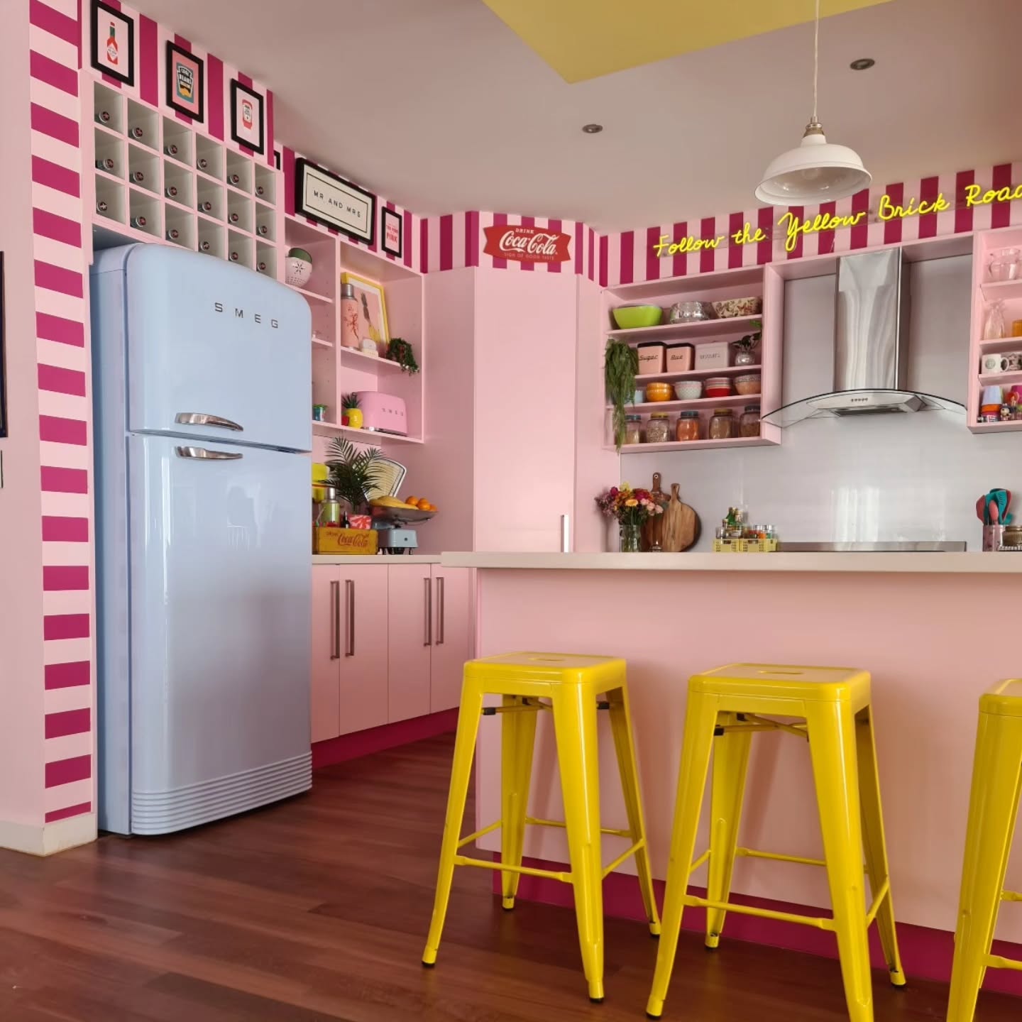 7. Raspberry Sorbet Cabinets with Geometric Gold Backsplash In a Petite Pink Kitchen