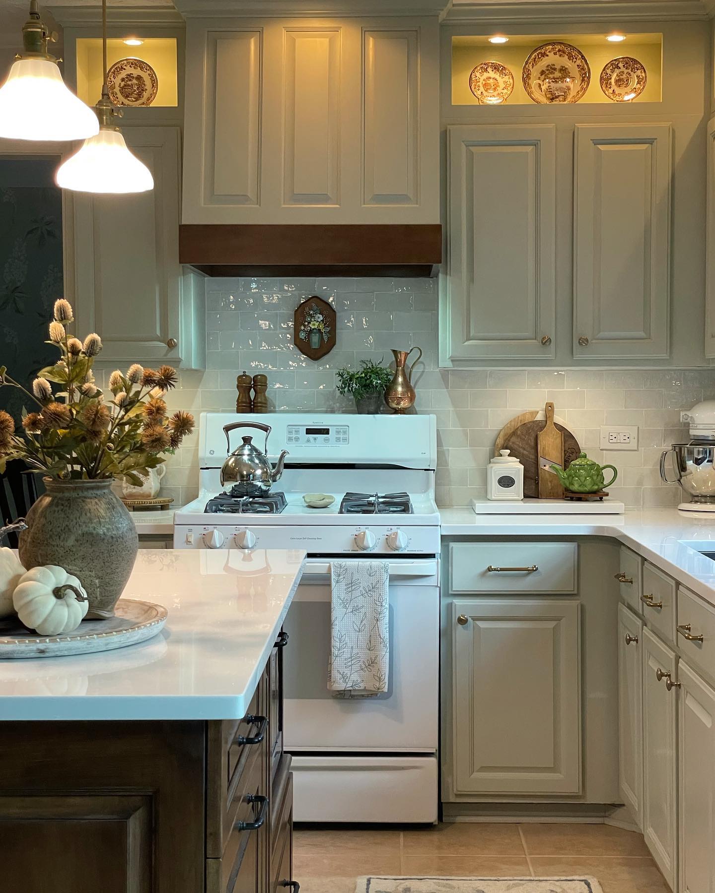 30. Vintage Emerald Cabinets with Copper Accents and Open Shelving