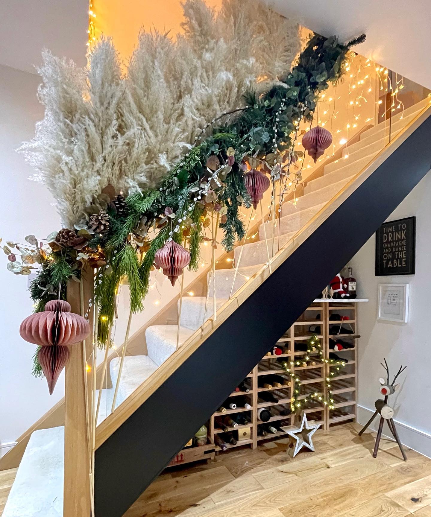 12. Snowflake Chandelier and Crimson Ribbon Garland Hallway