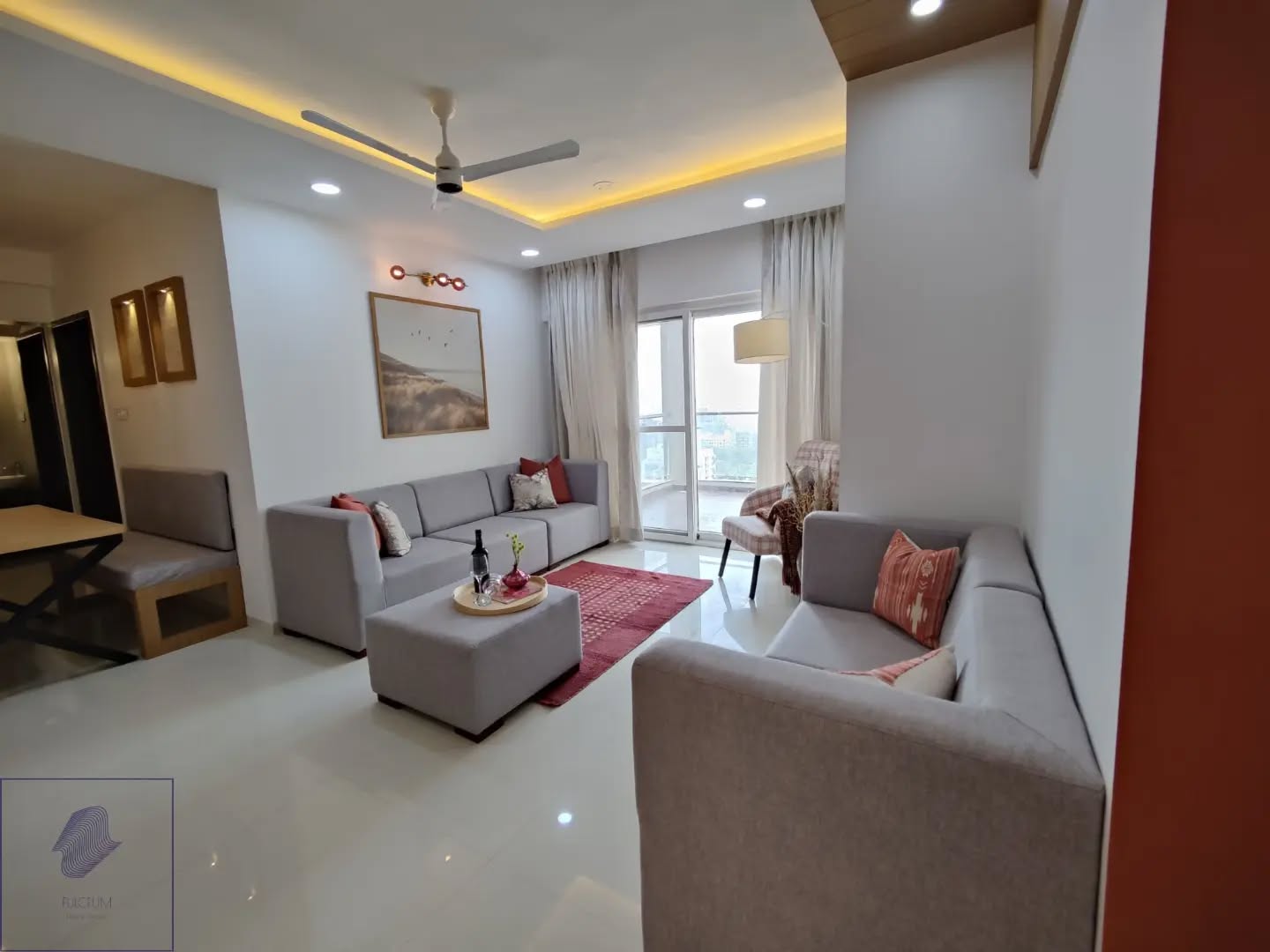 32. Vibrant Geometric Wall Art Above a Sleek White Sofa with Copper Accents