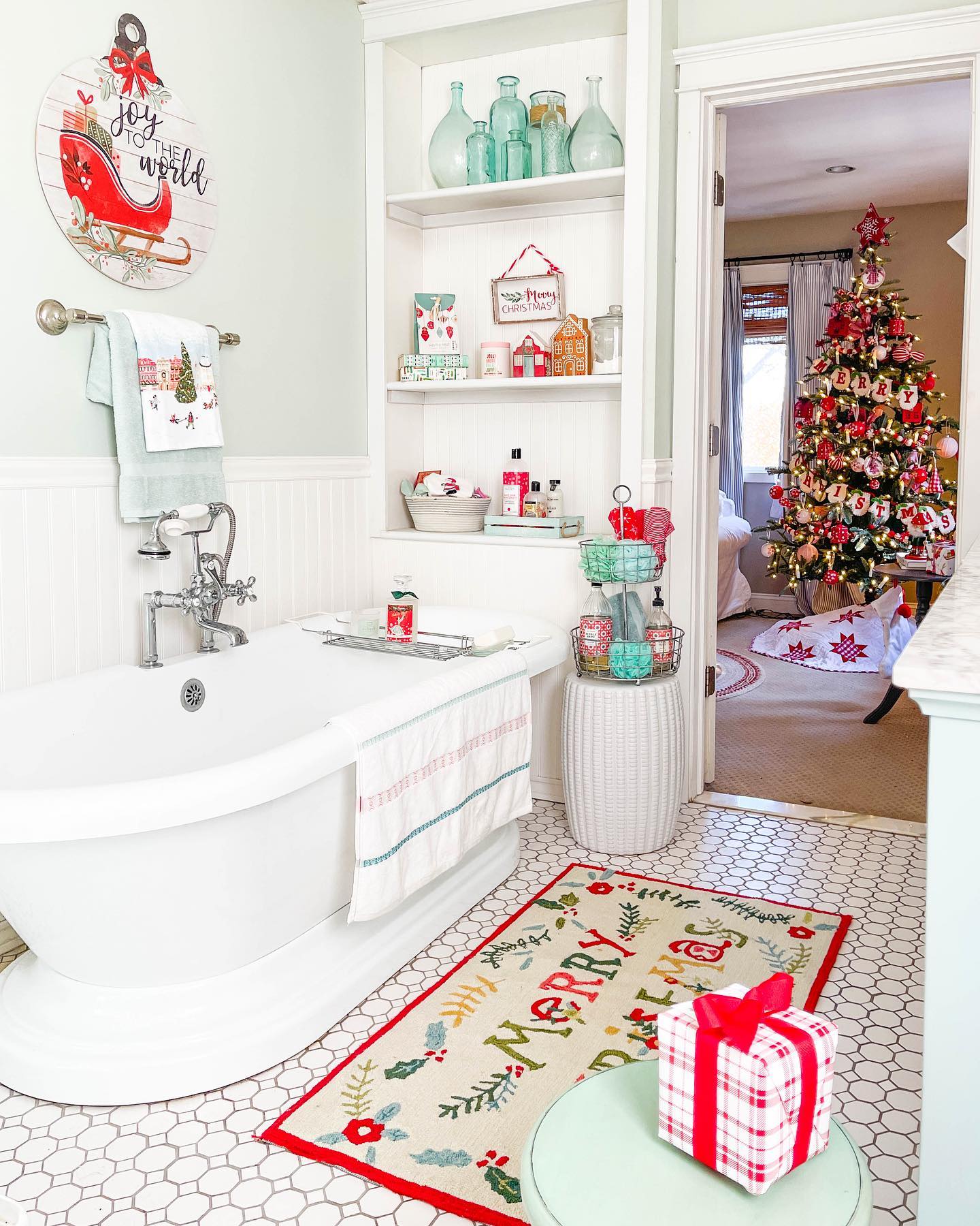 21. Festive Frosted Pinecones and Red Ribbon Towel Display
