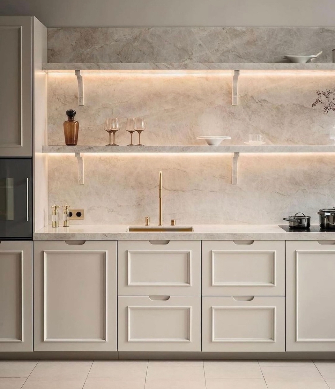 5. Cascading Quartz Countertops and Geometric Tile Accents In a Minimalist White Kitchen