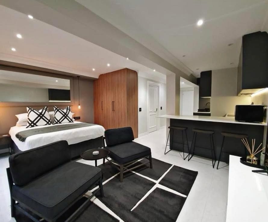 13. Neon Glow Compact Living: a Studio Apartment with Vibrant Accent Wall and Floating Shelves