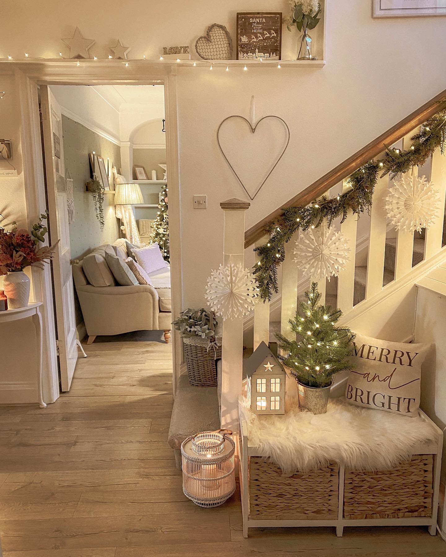 10. Festive Foliage and Crimson Ribbons Transform a Rustic Wooden Archway