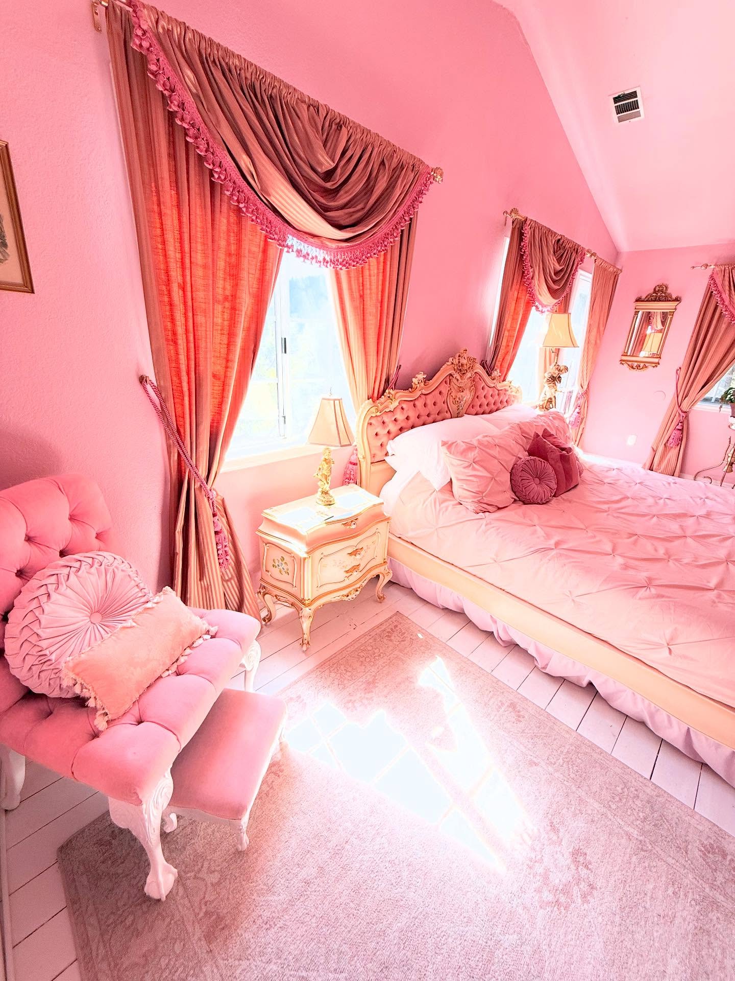 29. the Blush Pink Canopy Bed with Draped Floral Garland