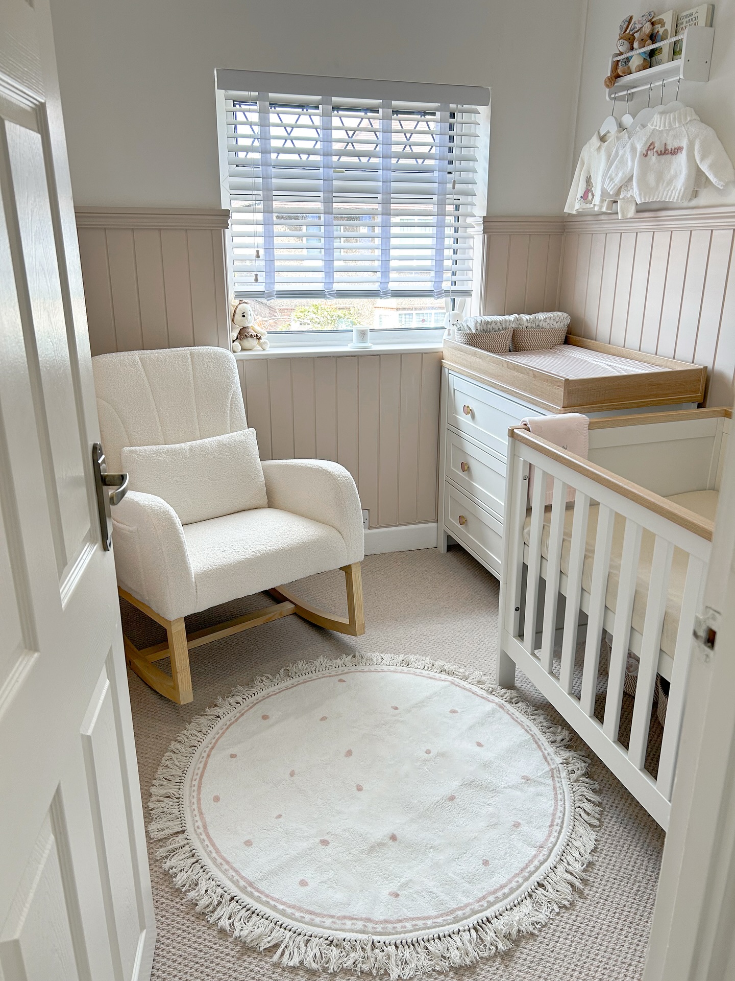 17. Vibrant Floral Wallpaper with Whimsical Giraffe Accent In a Cozy Nursery Nook