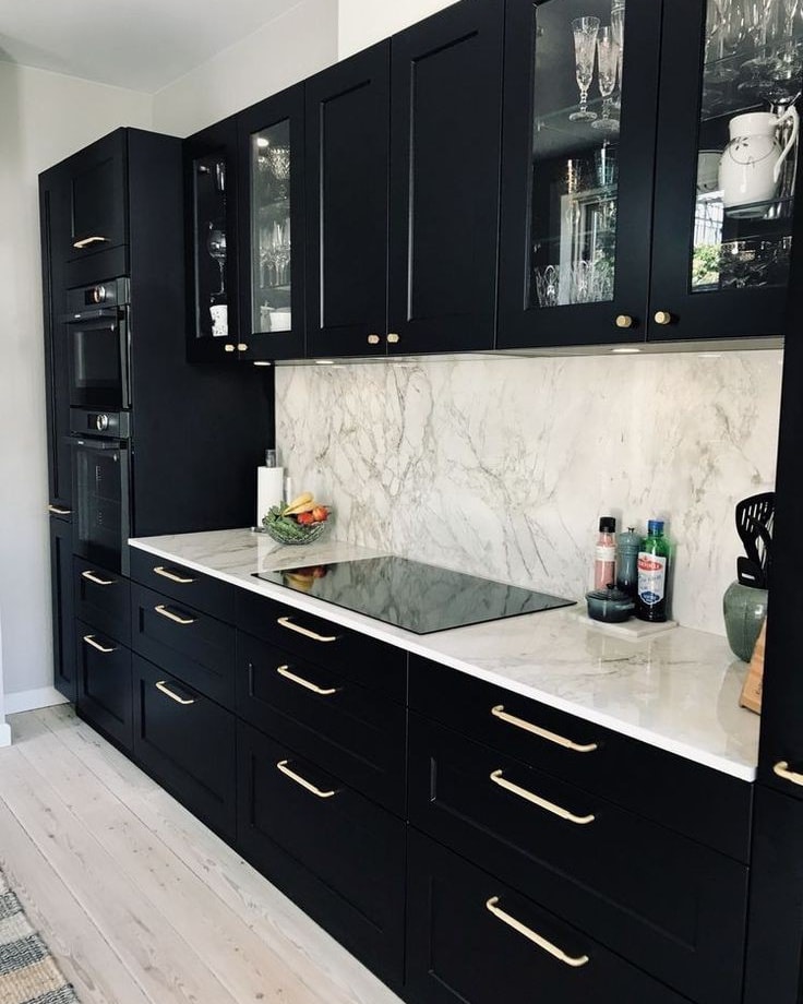 26. Glossy White Cabinets with Metallic Accents and Minimalist Hardware