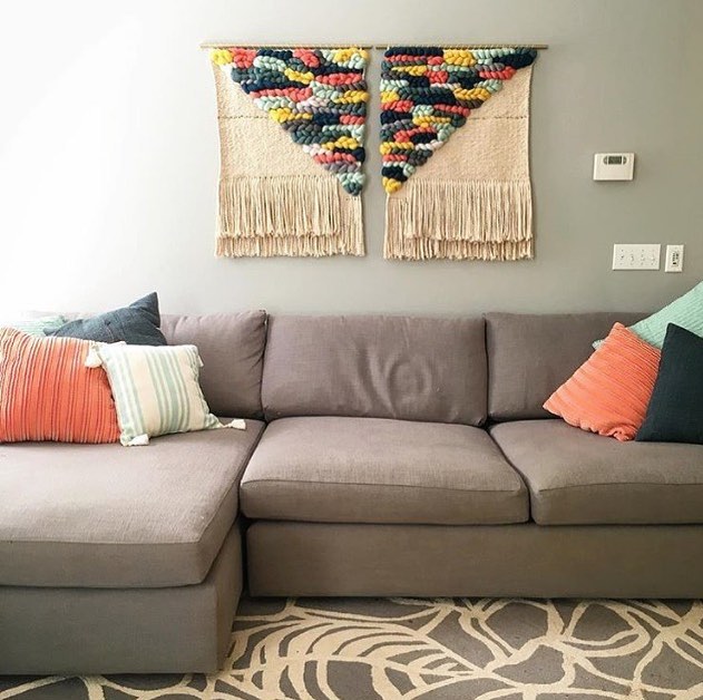 16. a Driftwood Mobile with Hanging Crystals and Feathers Above a Vintage Green Sofa