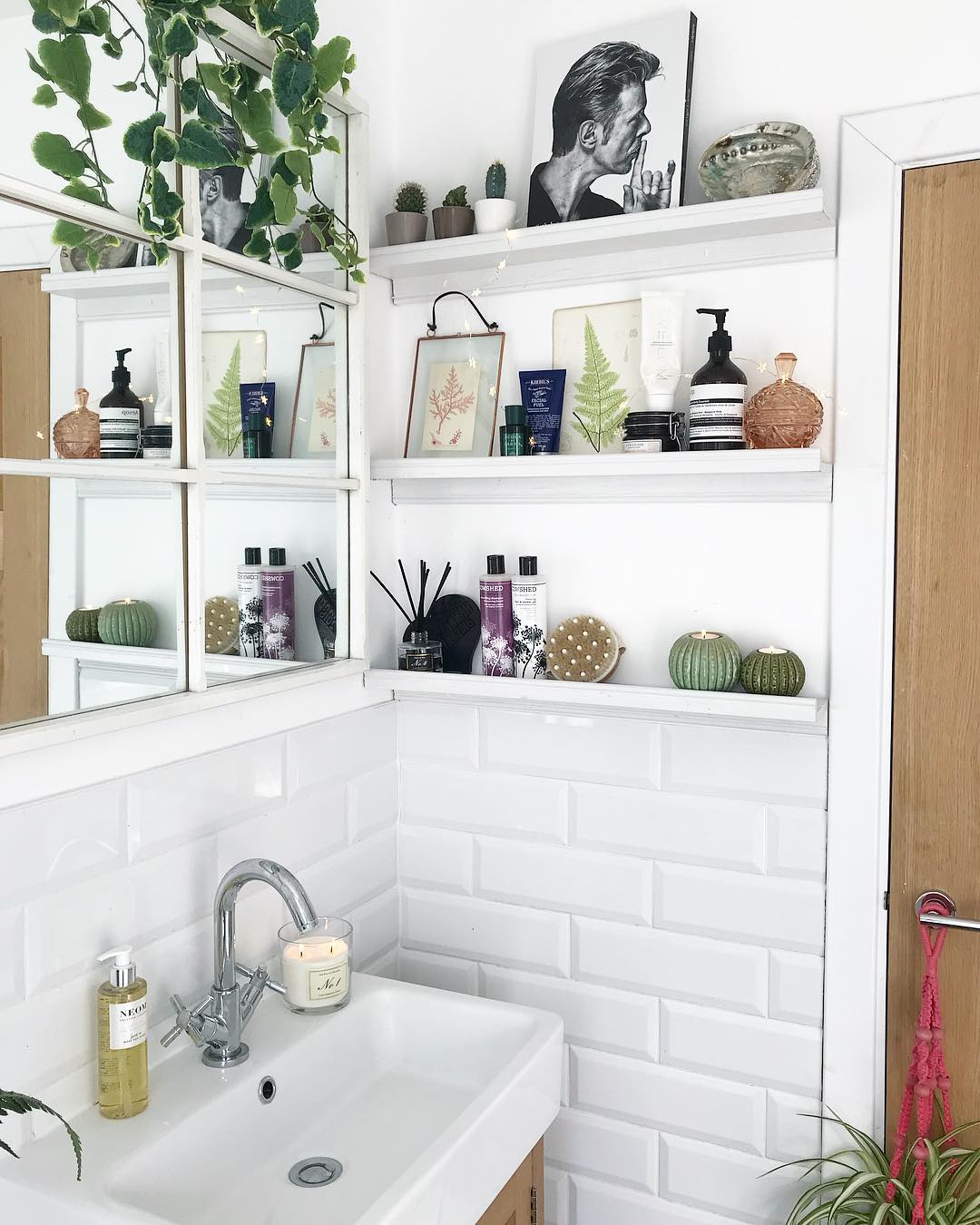 10. Floating Shelves and Wicker Baskets Create a Coastal Haven In a Petite Powder Room