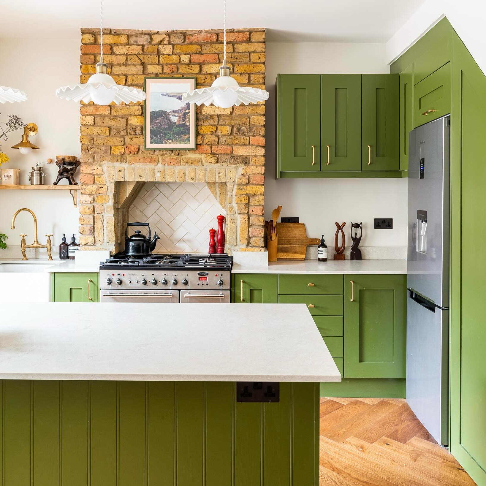 8. Mossy Green Cabinets with Woven Basket Accents and Copper Faucet